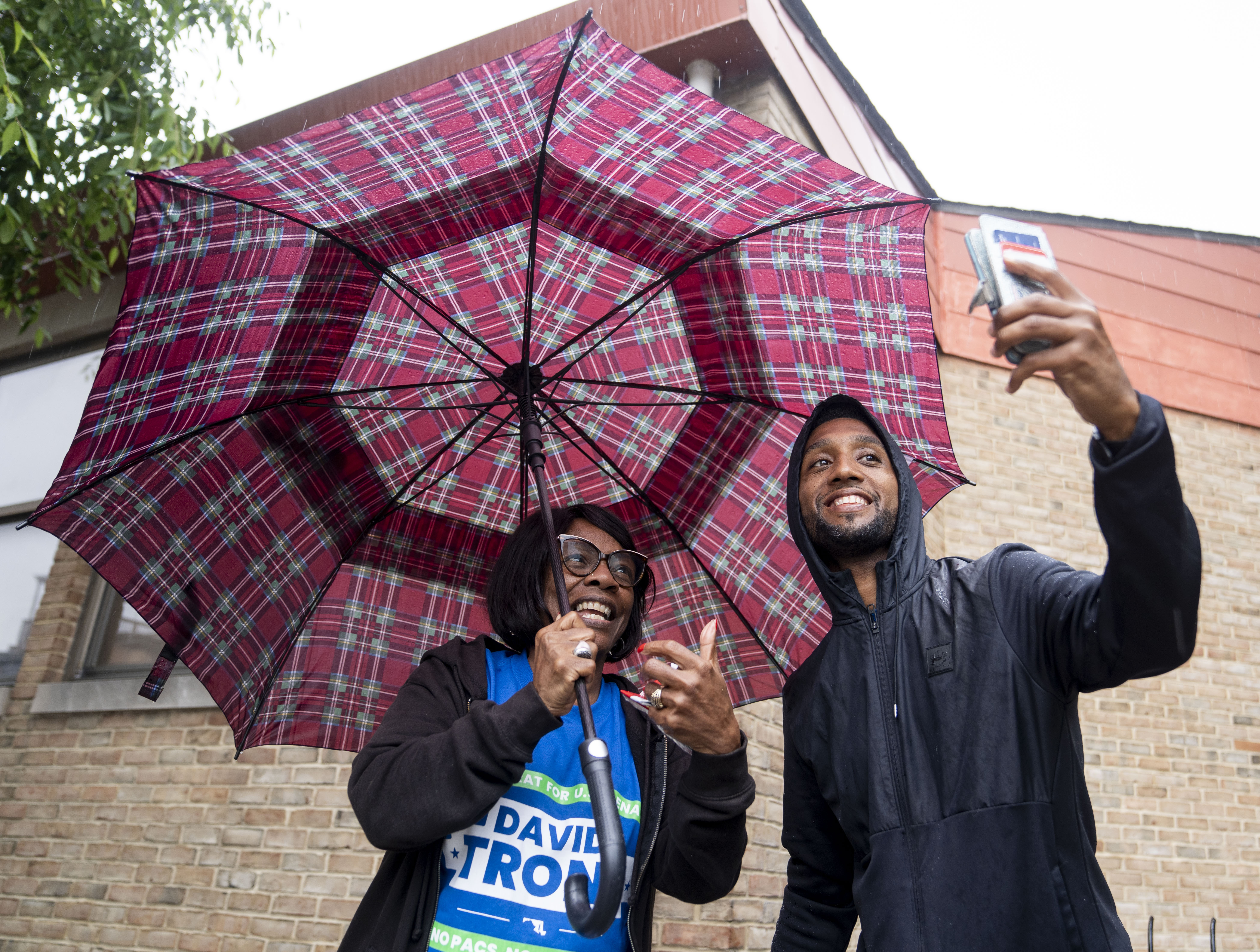 Mayor Brandon Scott takes a selfie with Sharon Baskin near Hatton Senior Center, in Baltimore, Tuesday, May 14, 2024. Scott was there to talk to voters before casting their ballots. (Jessica Gallagher/The Baltimore Banner)