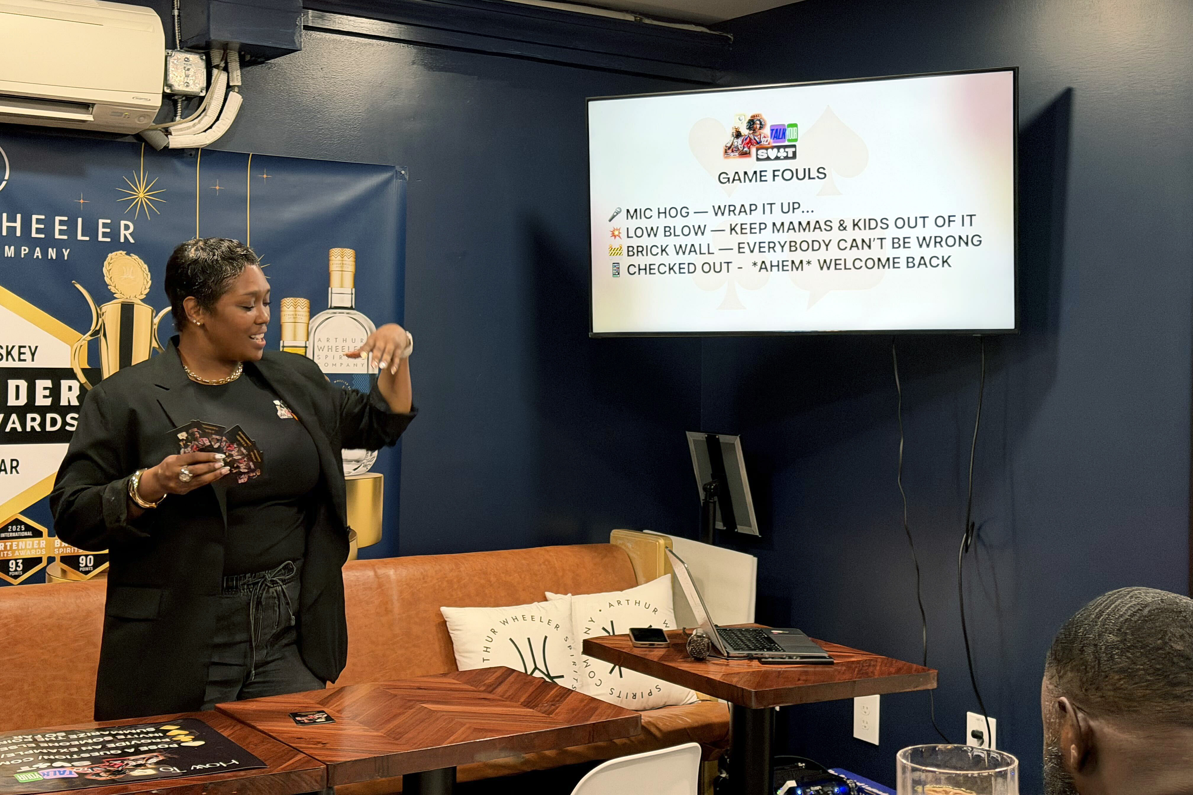 Cortnie Burriss hosts a game night every first Thursday of the month at Upper Marlboro’s Free State Distillery. Patrons play “Talk Your Suit,” a game Burriss originally created for her high school literature students and encourages players to use different conversation skills.