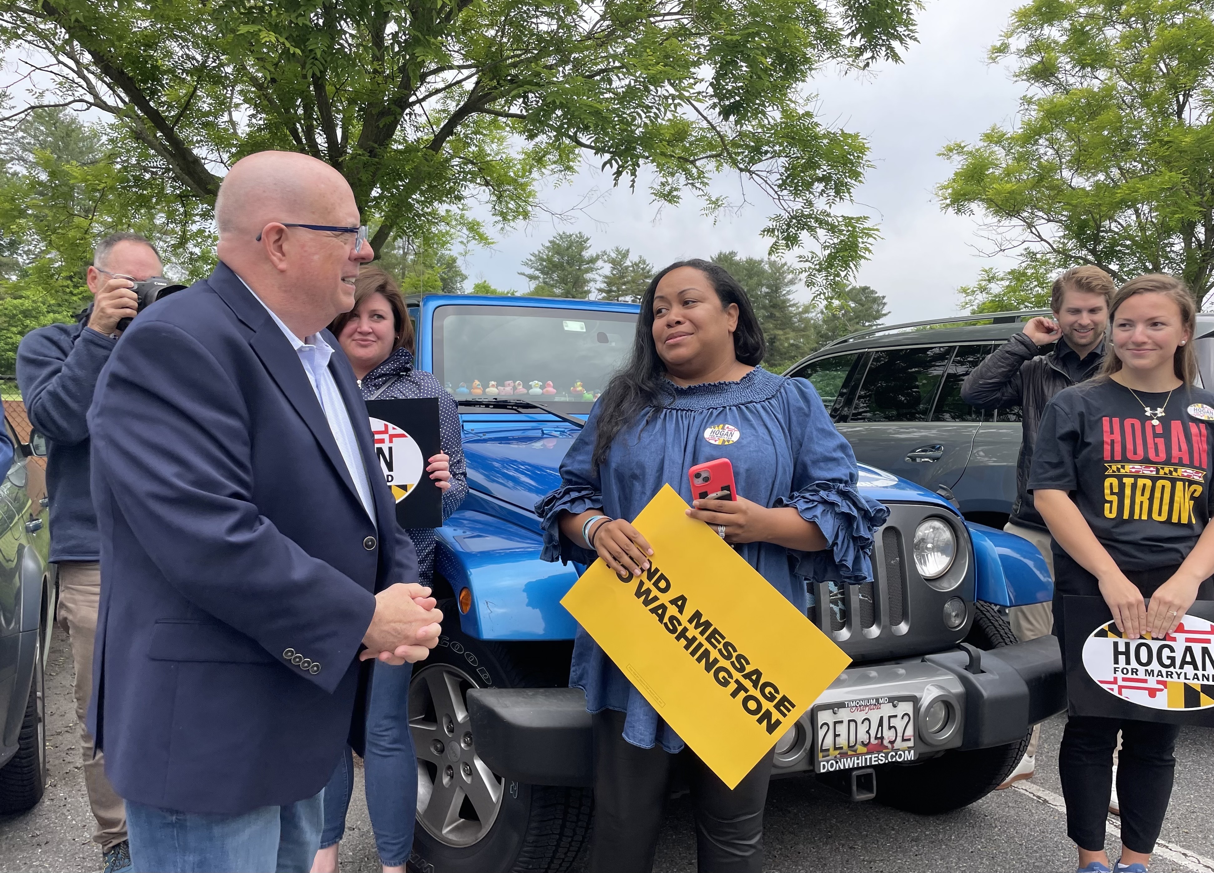 Former Maryland Gov. Larry Hogan and his wife, Yumi, with supporters. (Pam Wood/The Baltimore Banner)