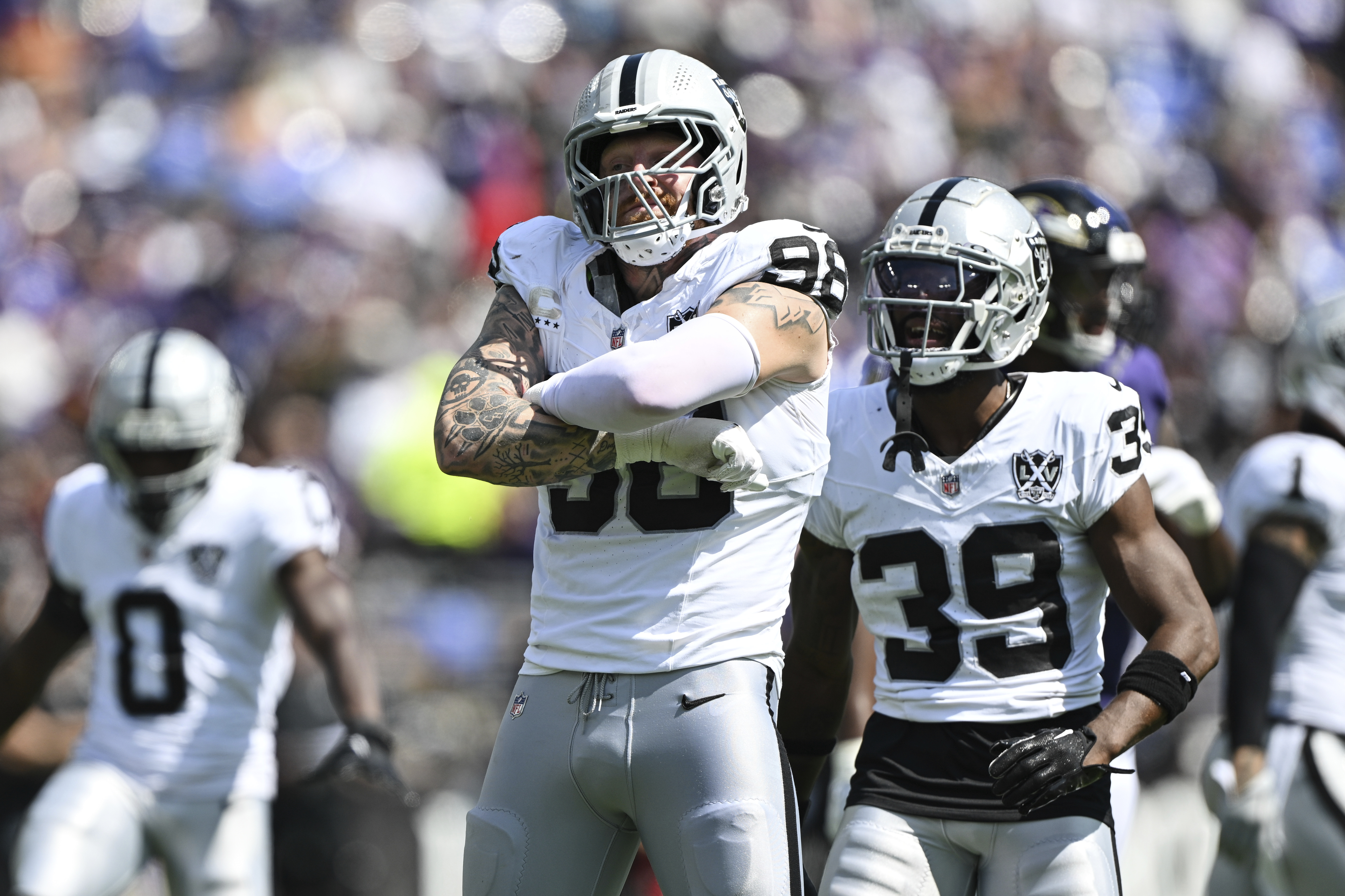 Las Vegas Raiders defensive end Maxx Crosby (98) celebrates a sack of Baltimore Ravens quarterback Lamar Jackson, not pictured, with teammate cornerback Nate Hobbs (39) during the first half of an NFL football game, Sunday, Sep. 15, 2024, in Baltimore. (AP Photo/Terrance Williams)