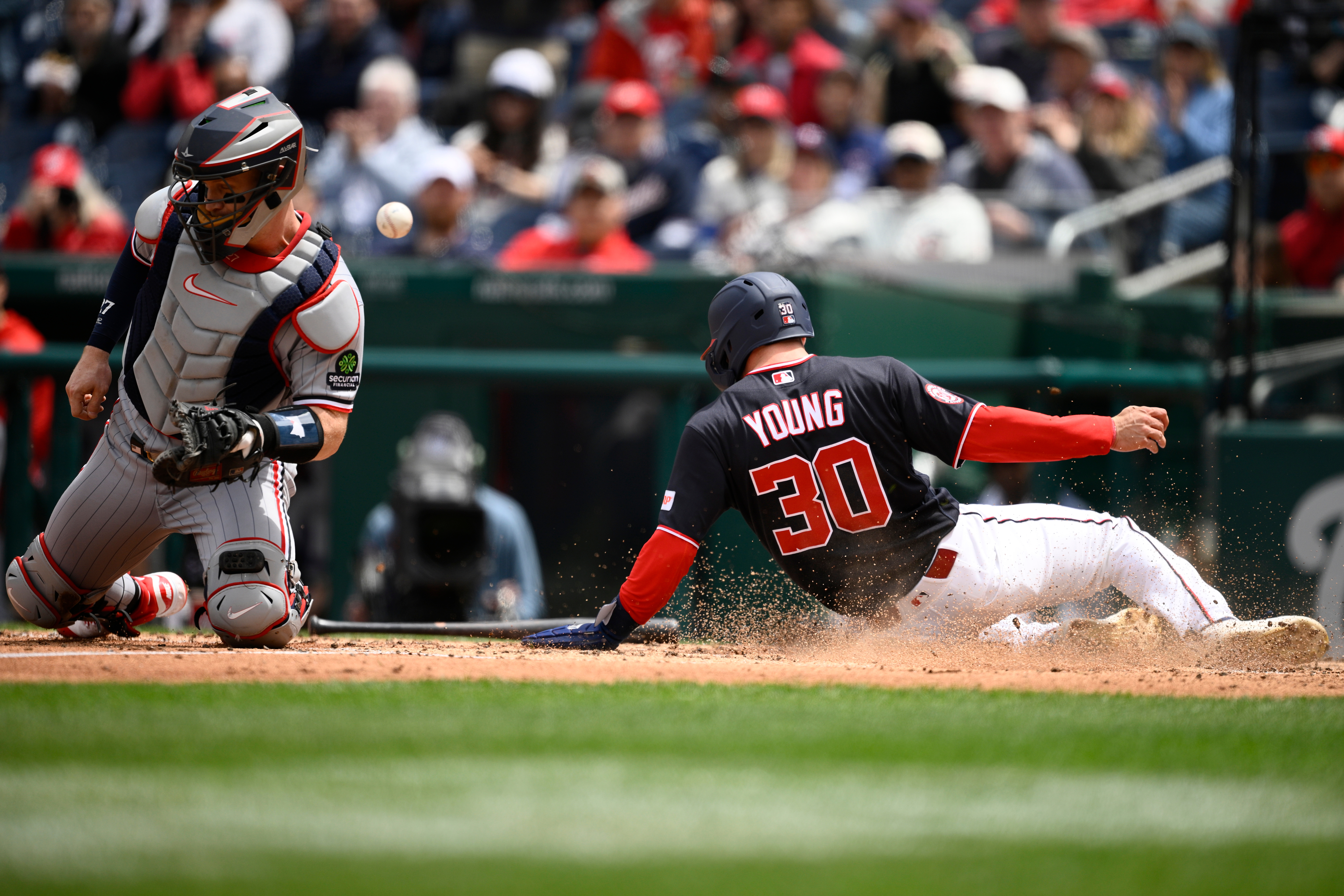 Washington Nationals center fielder Jacob Young slides home to score on a double by Keibert Ruiz in the third inning.