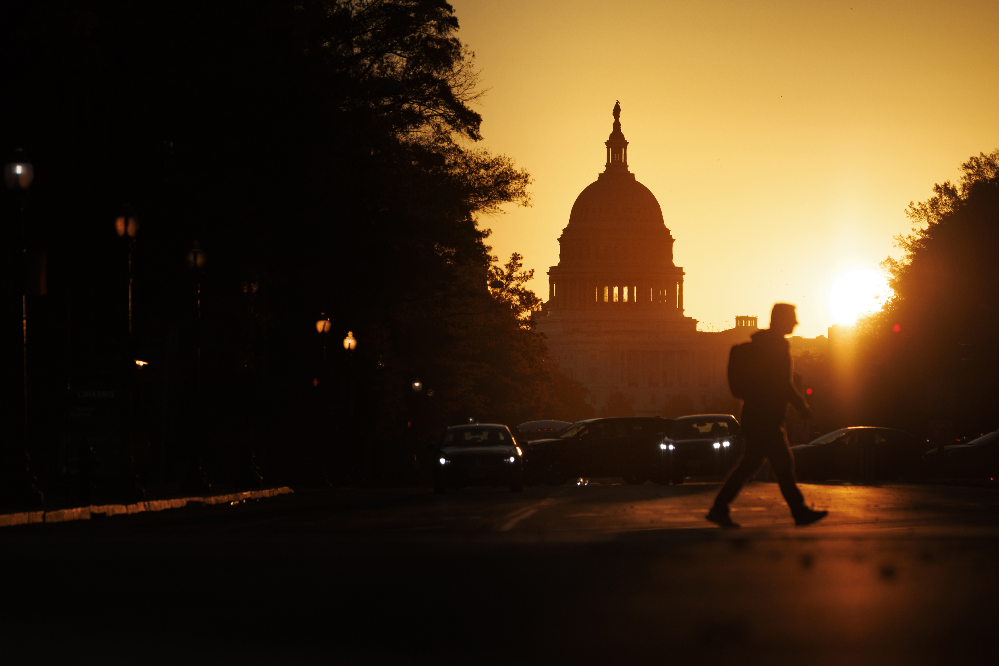 WASHINGTON, DC - NOVEMBER 5: A pedestrian walks along Pennsylvania Avenue near the U.S. Capitol during sunrise on November 5, 2025 in Washington, DC. The record for longest shutdown in the U.S. Government was broken Wednesday as it entered its 36th day.