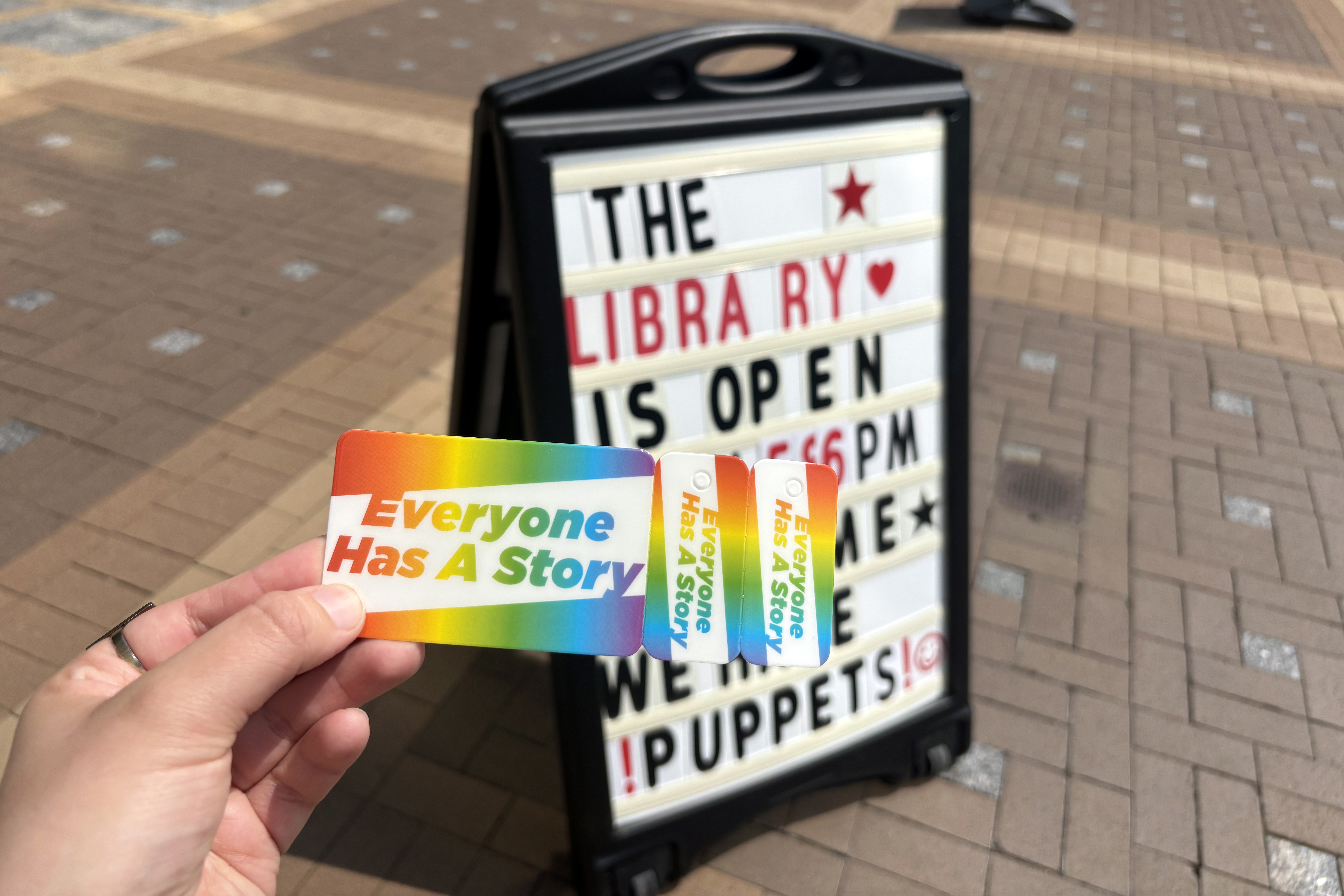 Reporter Ginny Bixby with a newly obtained library card outside the Courthouse Library in Arlington, Virginia.