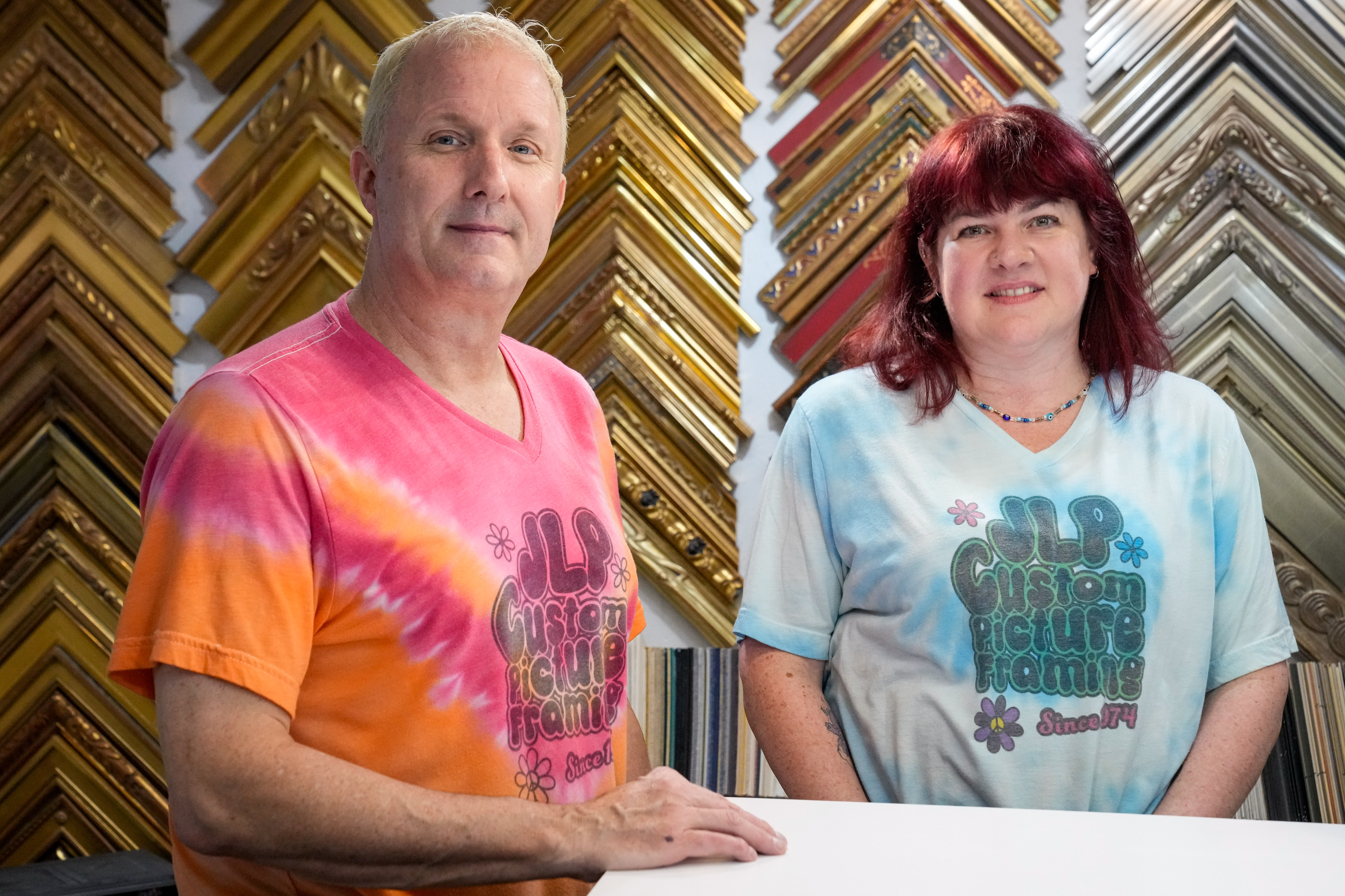 Thom, left, and Carol Stone, owners of JLP Custom Picture Framing, are interviewed inside their store in Baltimore on Wednesday, October 2, 2024.