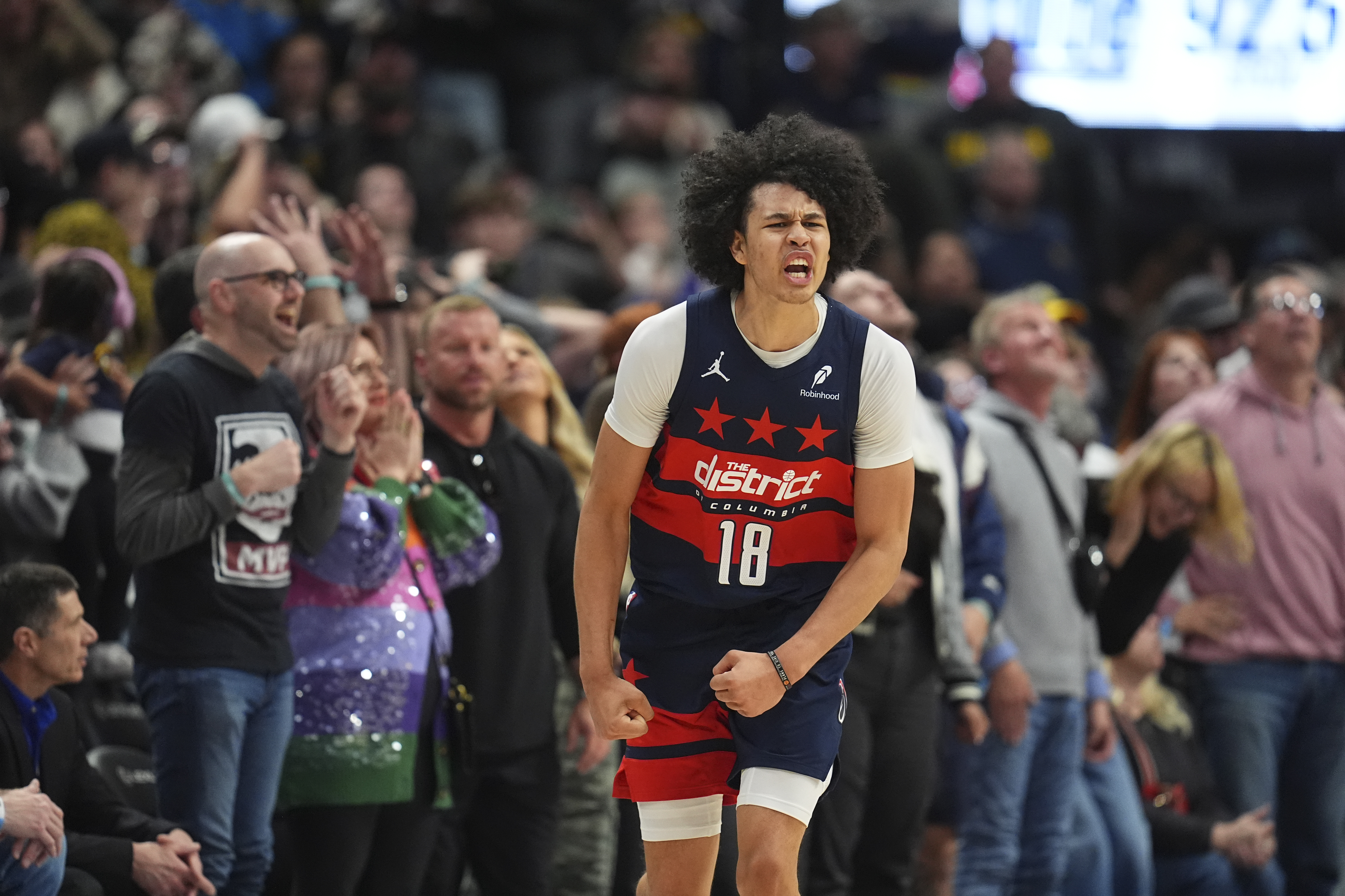 Washington Wizards forward Kyshawn George (18) reacts after hitting a 3-point basket in the second half of an NBA basketball game Saturday, March 15, 2025, in Denver.