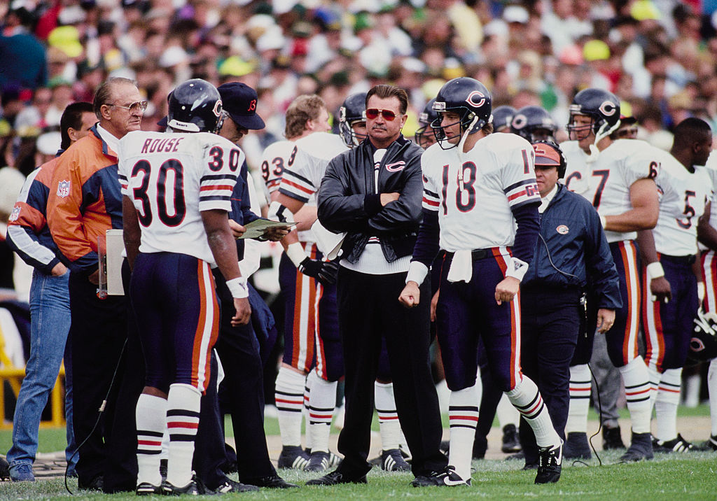 Mike Ditka, head coach for the Chicago Bears, looks on with arms folded from the sideline during the National Football Conference Central Division game against the Green Bay Packers on 16th September 1990 at Lambeau Field in Green Bay, Wisconsin, United States. The Chicago Bears won the game 31 - 13.