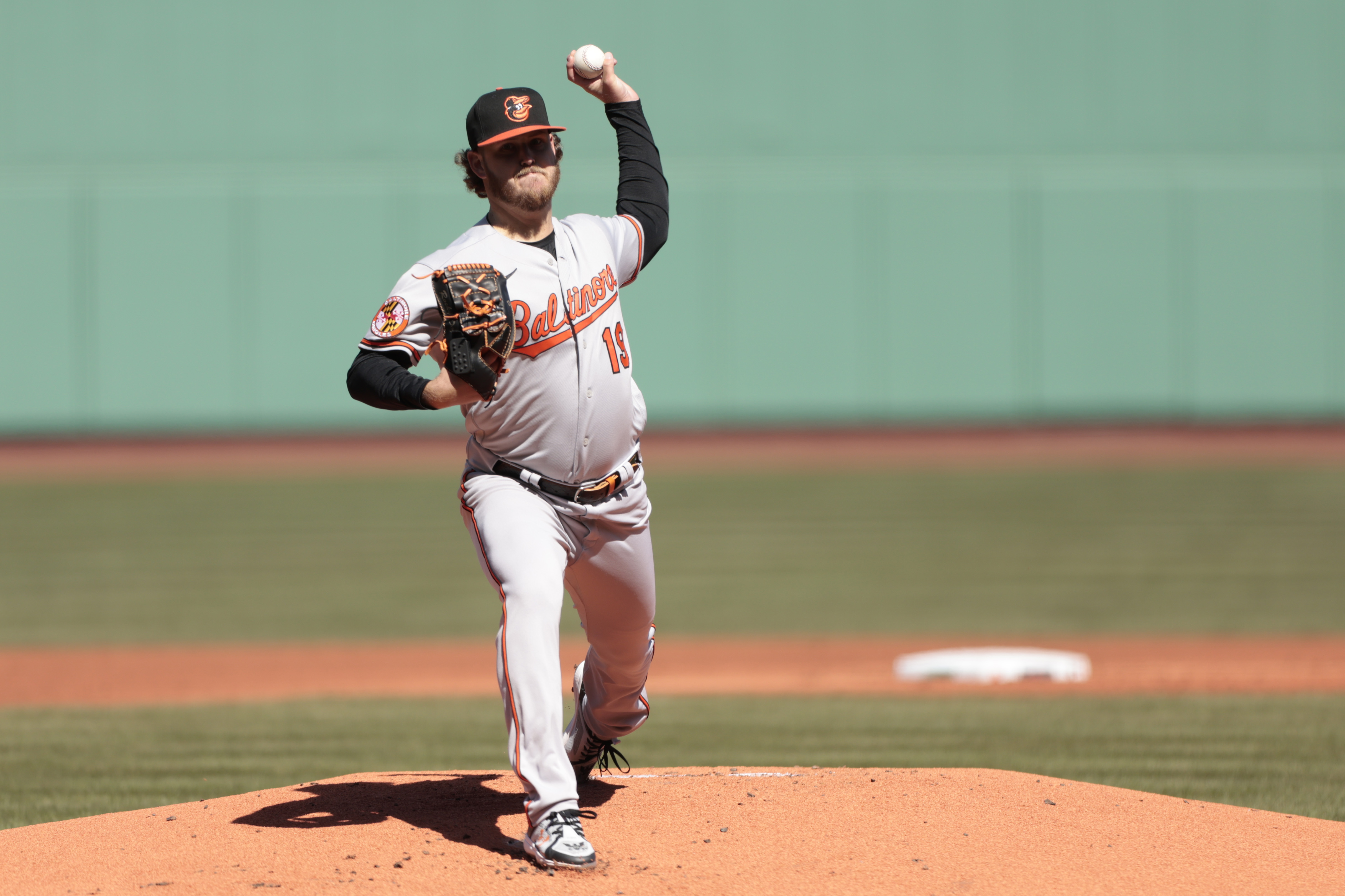 Pitcher Mychal Givens throws during the first day of workouts for