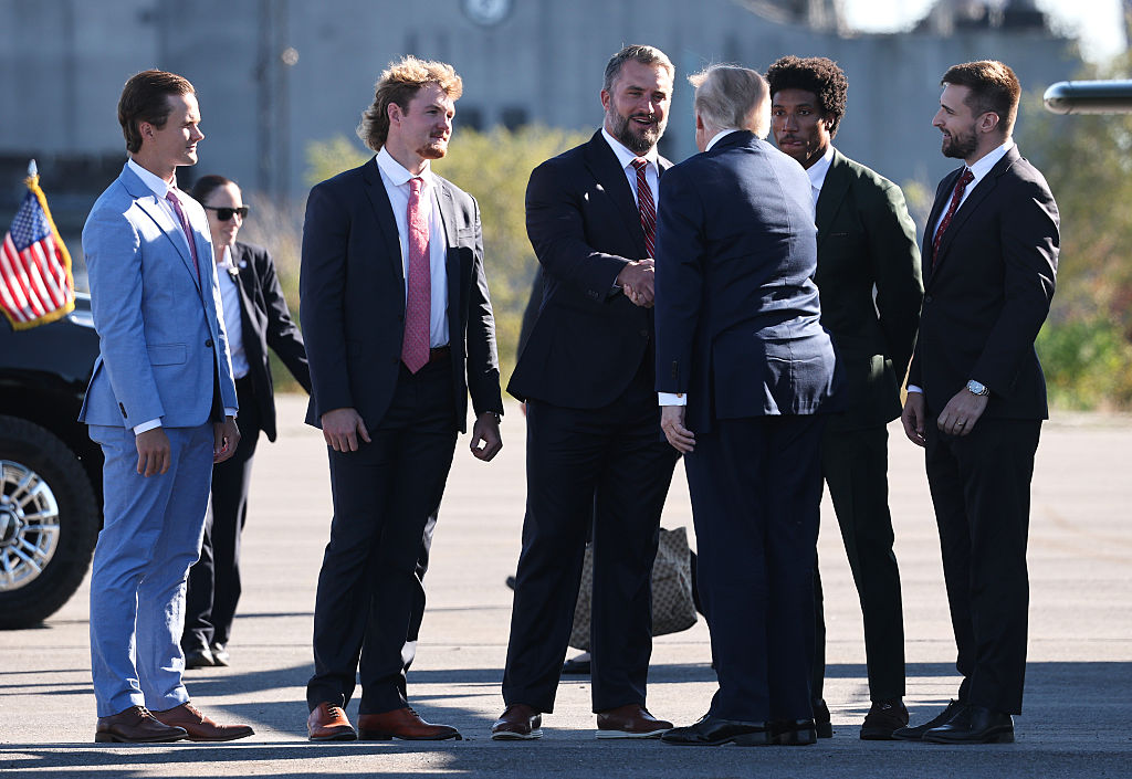 President Donald Trump greets members of the Baltimore Ravens, from left to right, kicker Tyler Loop, punter Ryan Eckley, long snapper Nick Moore and cornerback Marlon Humphrey, and political consultant Alex Bruesewitz as he arrives to speak at Tradepoint Atlantic on Tuesday.