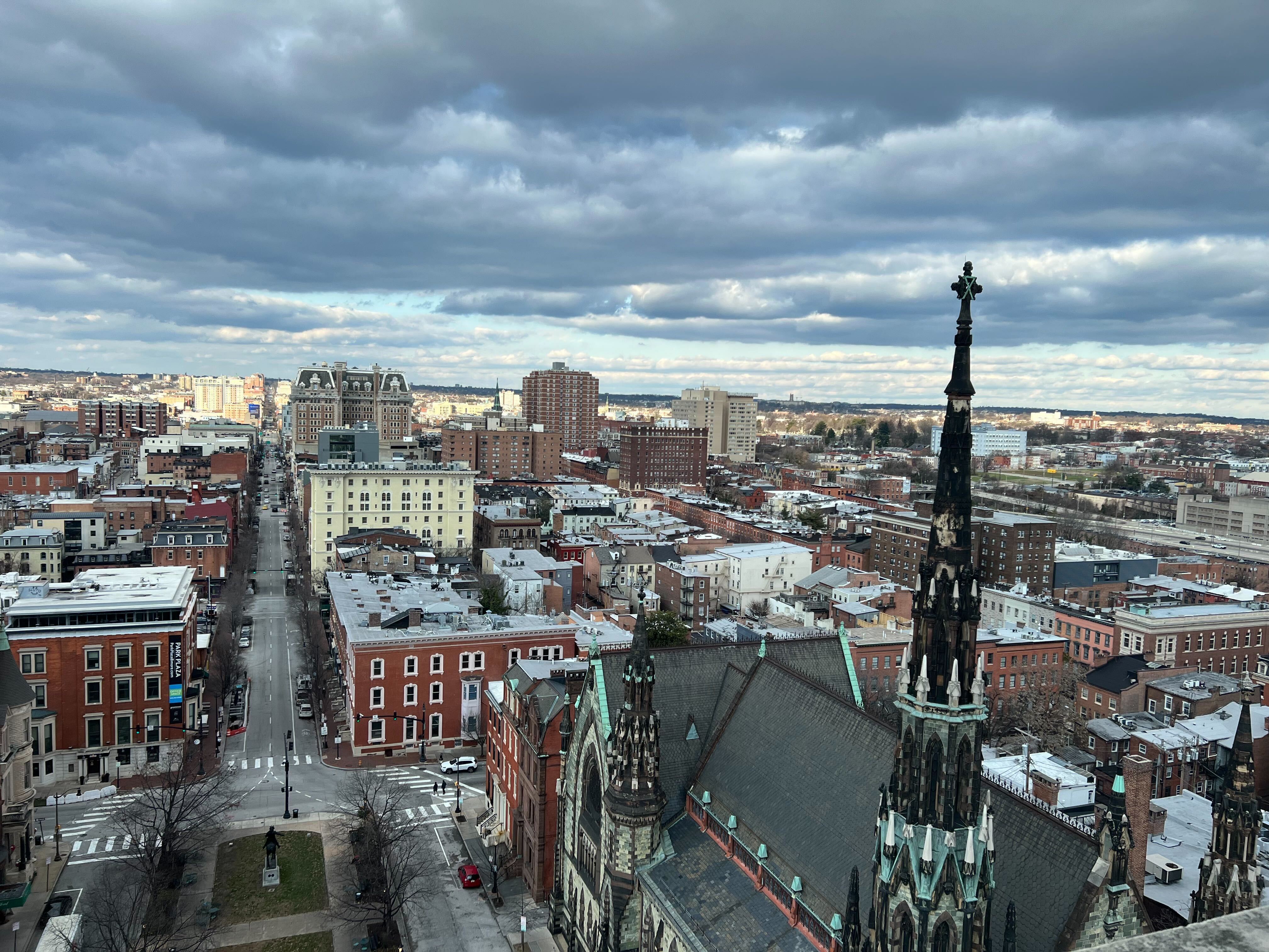 An old steeple breaks the skyline with clouds overhead.