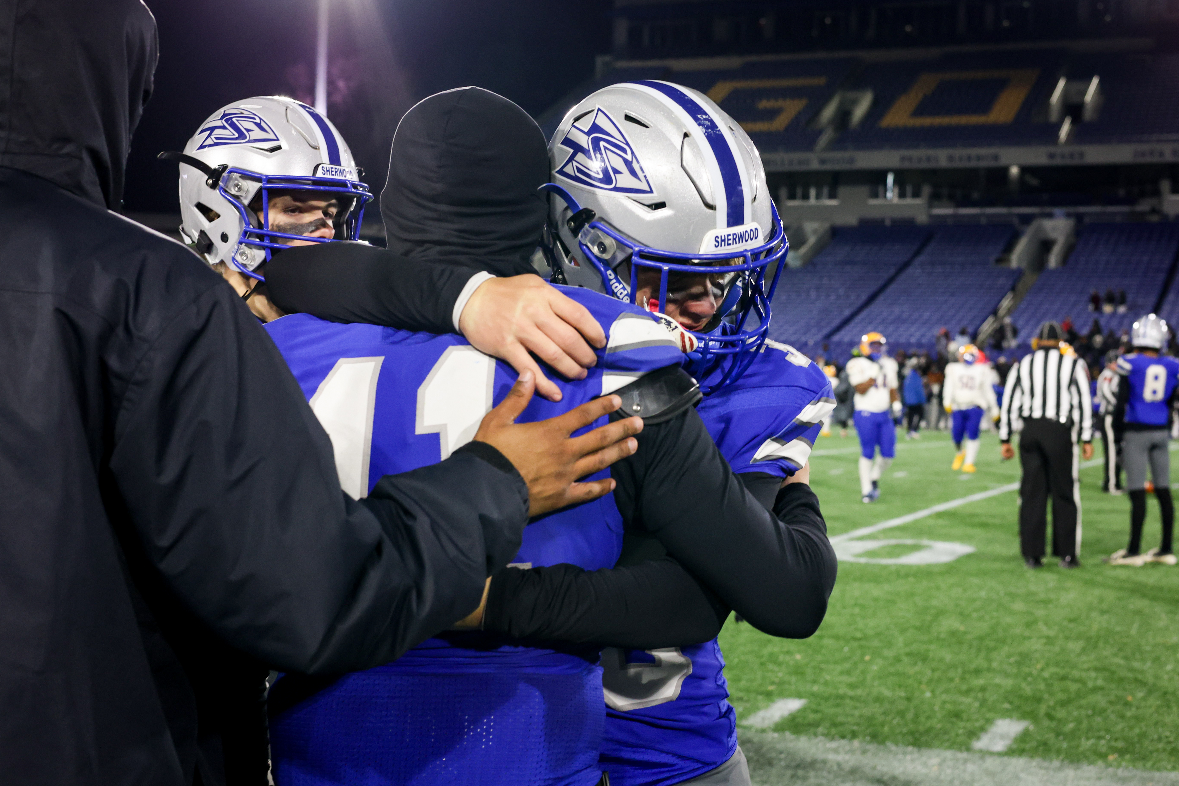 Sherwood players console each other after losing to the Mergenthaler Mustangs at Thursday’s Maryland State Football Championships at the Navy-Marine Corps Memorial Stadium in Annapolis.