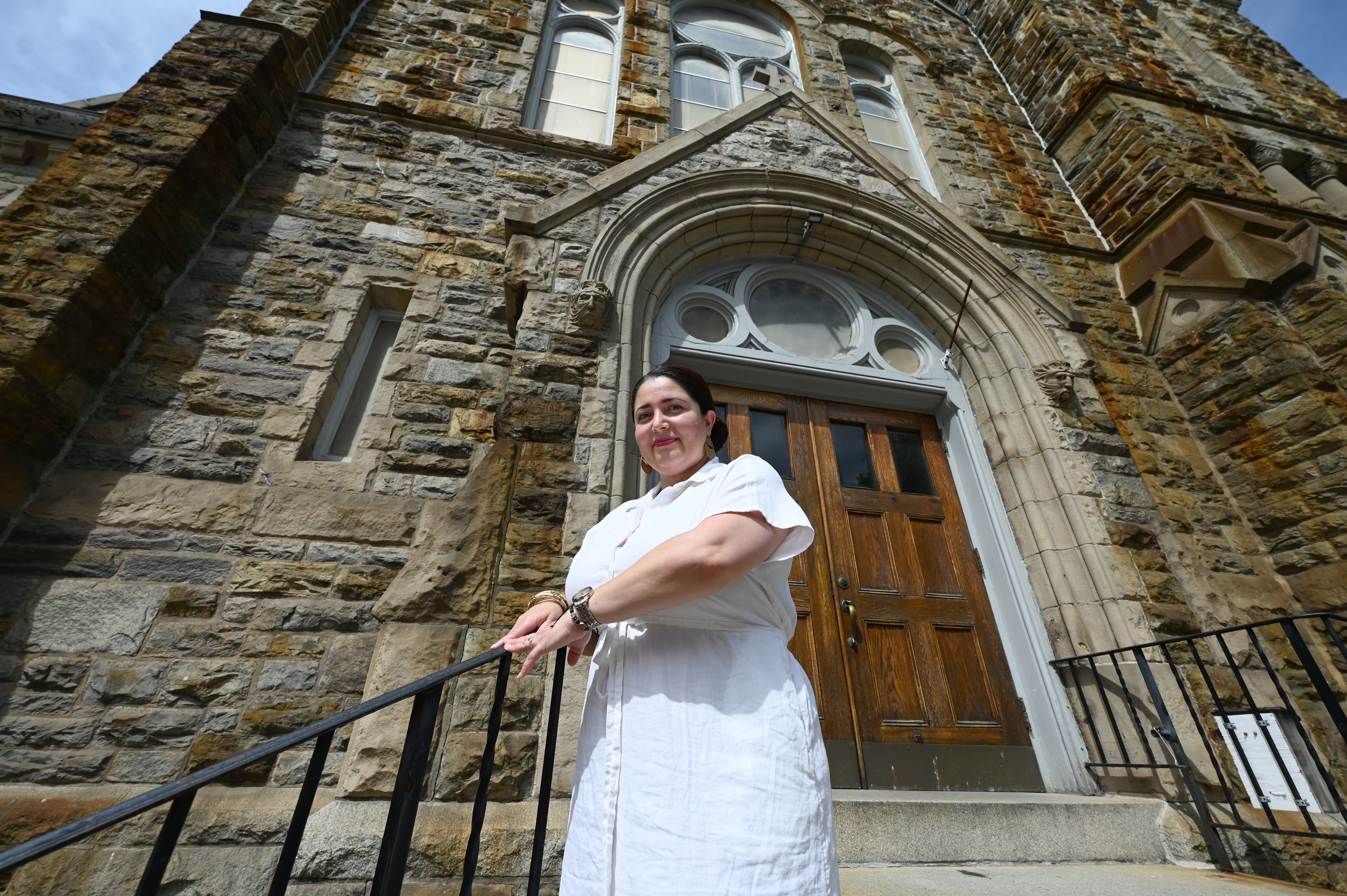 Cynthia Mendoza poses for a photograph in front of Our Lady of Good Counsel Catholic Church Wednesday, May 8, 2024 in Baltimore.
