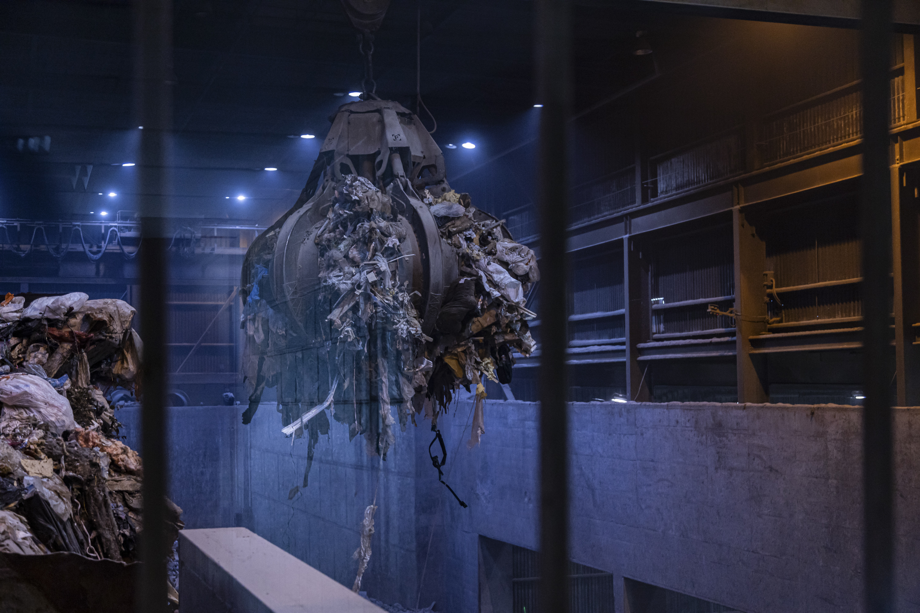 A giant claw moves garbage around the room where the waste is held at the Montgomery County resource recovery facility on Wednesday September 17th. Waste needs to be periodically moved around in order to keep the organic material that is decomposing and generating heat from creating a fire in the facility.