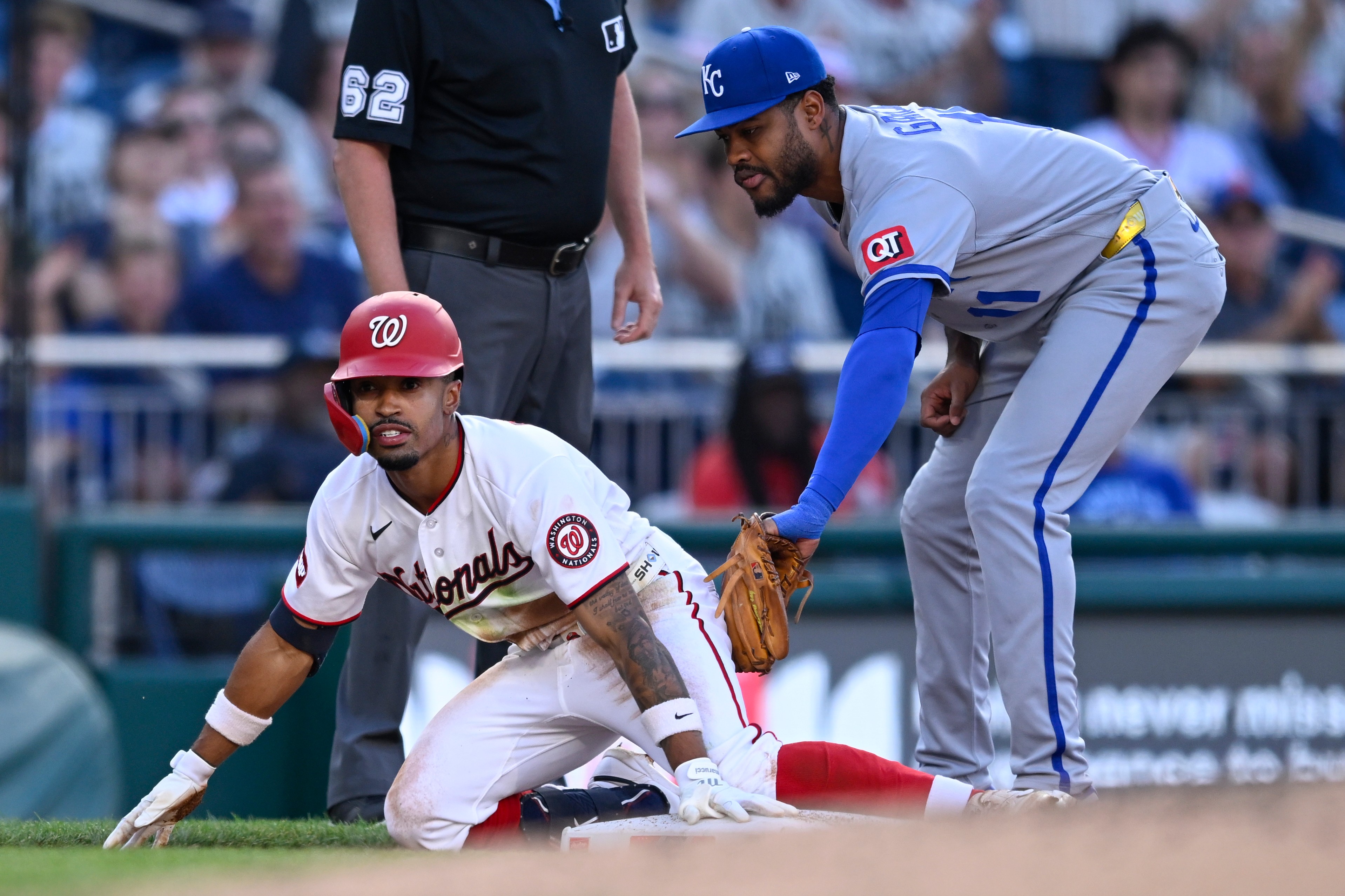 Washington Nationals' Nasim Nuñez beats the tag by Kansas City Royals third baseman Maikel Garcia for an RBI triple during the third inning.