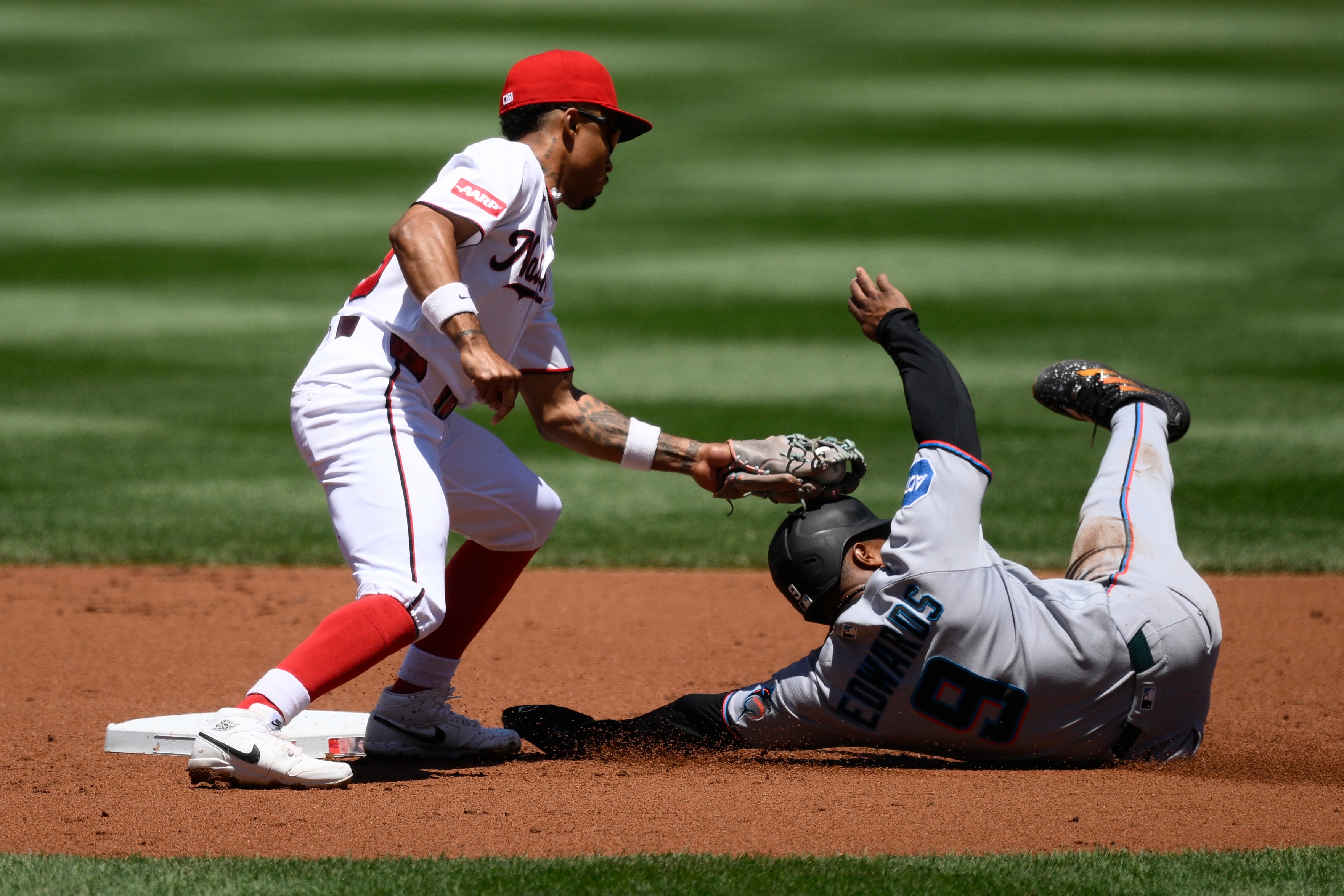 Miami Marlins' Xavier Edwards, right, is out attempting to steal second against Washington Nationals second baseman Nasim Nunez, left, during the second inning of a baseball game, Wednesday, June 3, 2026, in Washington. (AP Photo/Nick Wass)