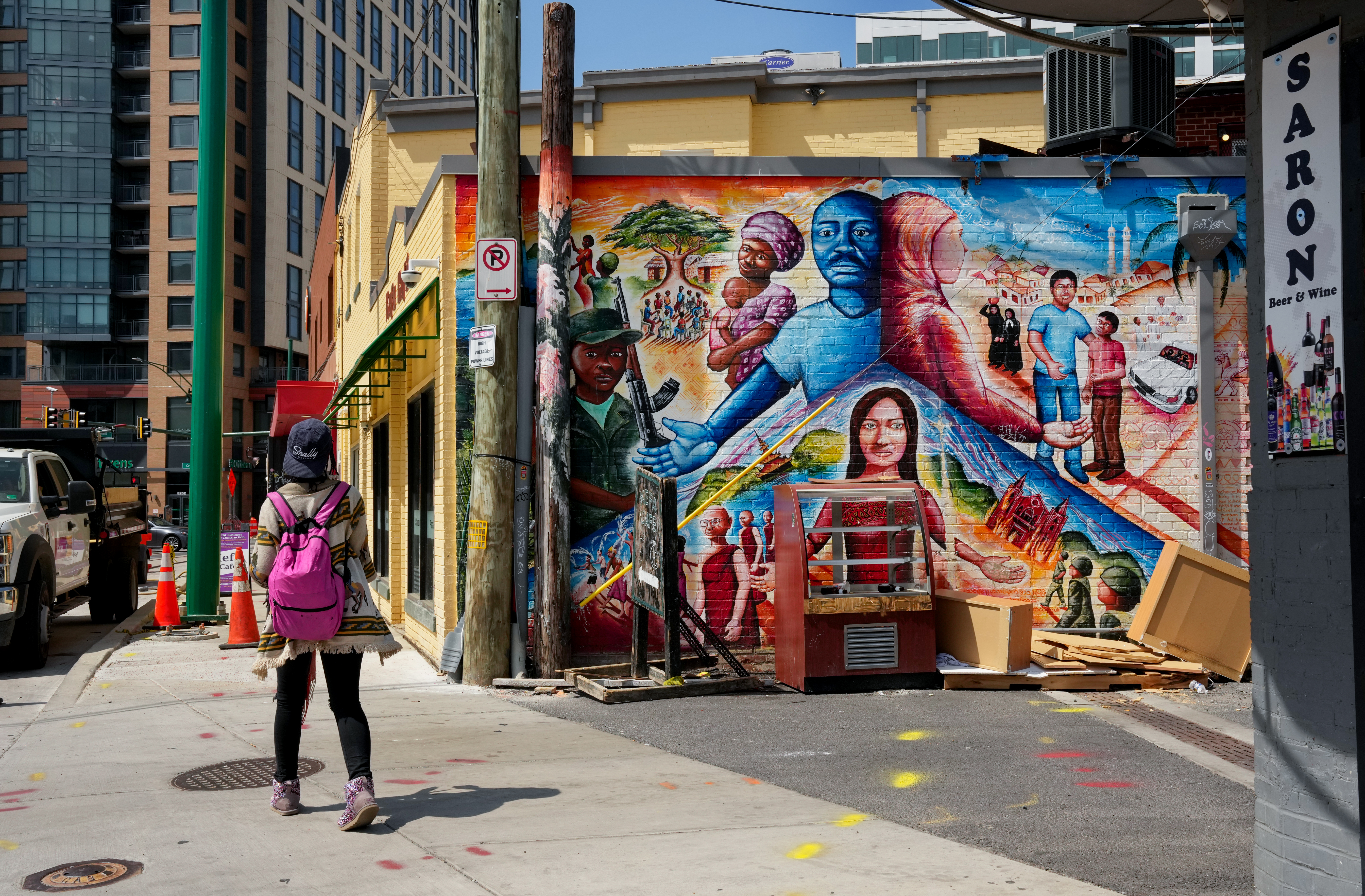 A pedestrian walks past a colorful mural near downtown Silver Spring, Maryland, U.S.
