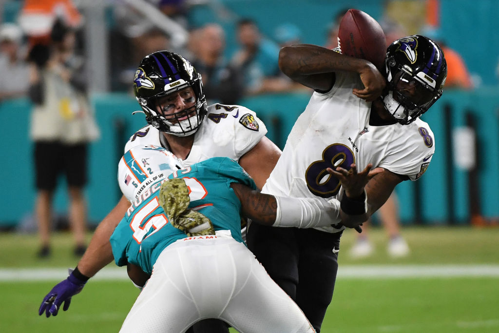 Ravens quarterback Lamar Jackson is sacked by Miami Dolphins linebacker Elandon Roberts in November 2021.