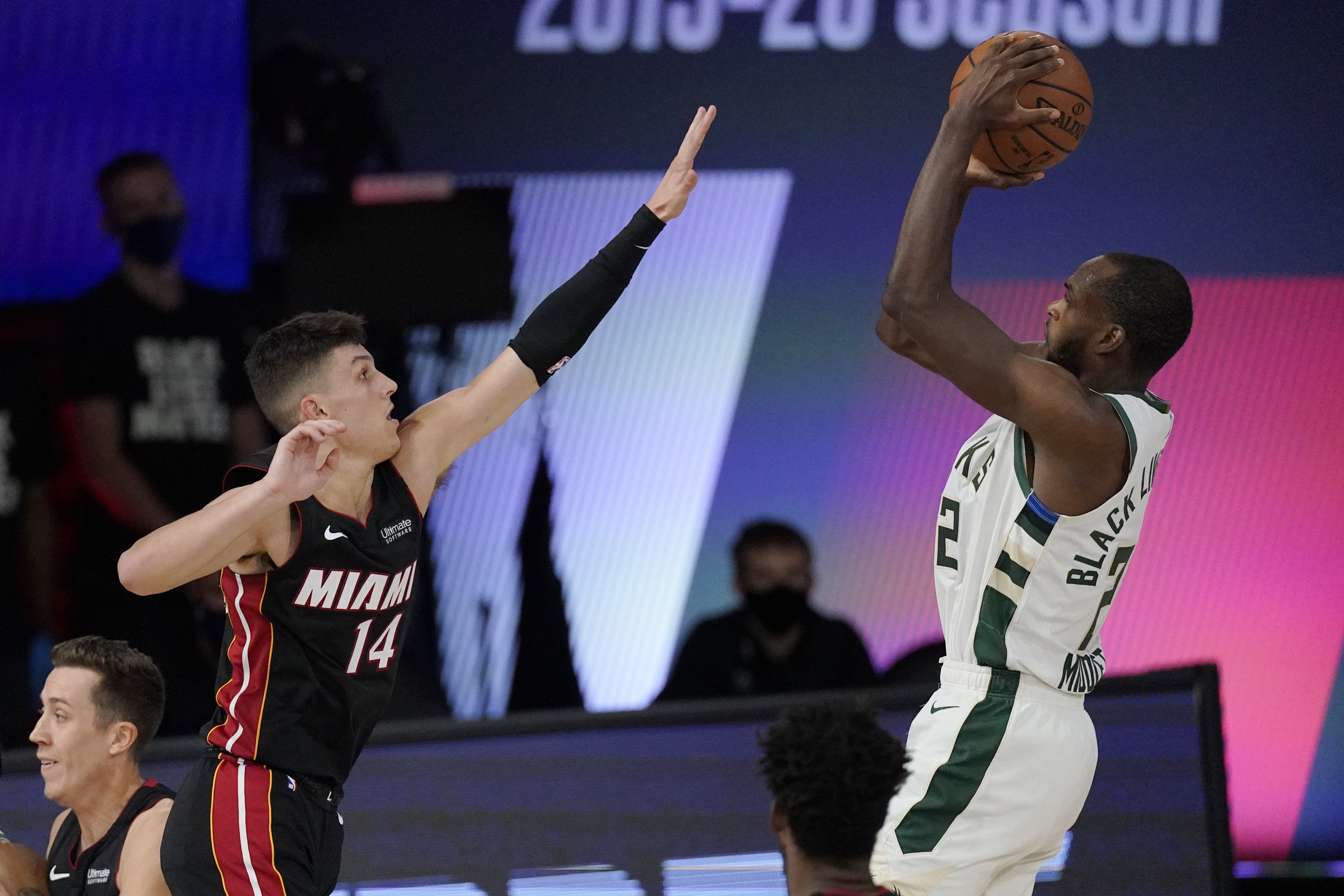 Tyler Herro defends Khris Middleton during a recent playoff contest.