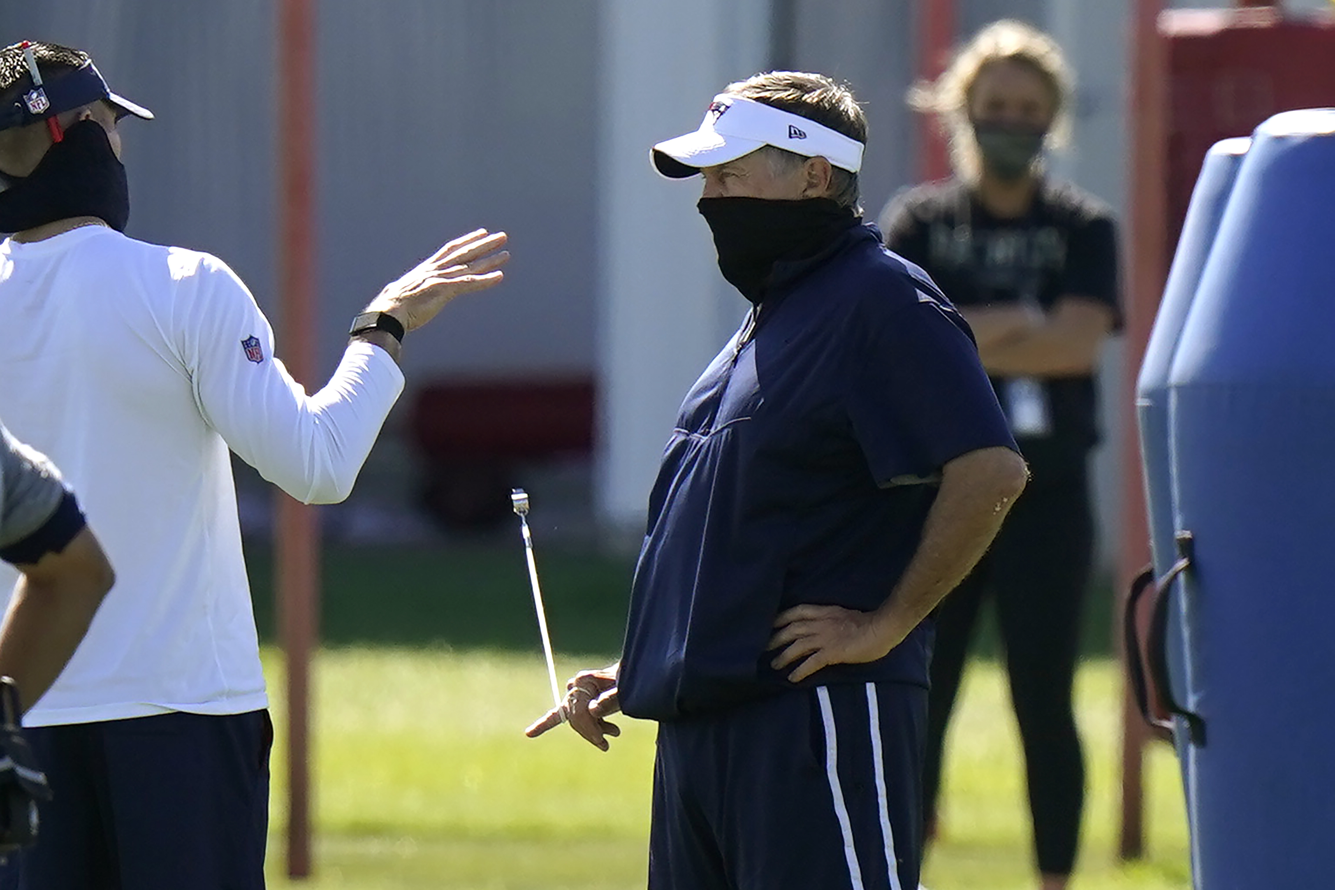 Bill Belichick speaks with director of player personnel Nick Caserio before a recent workout in Foxborough.