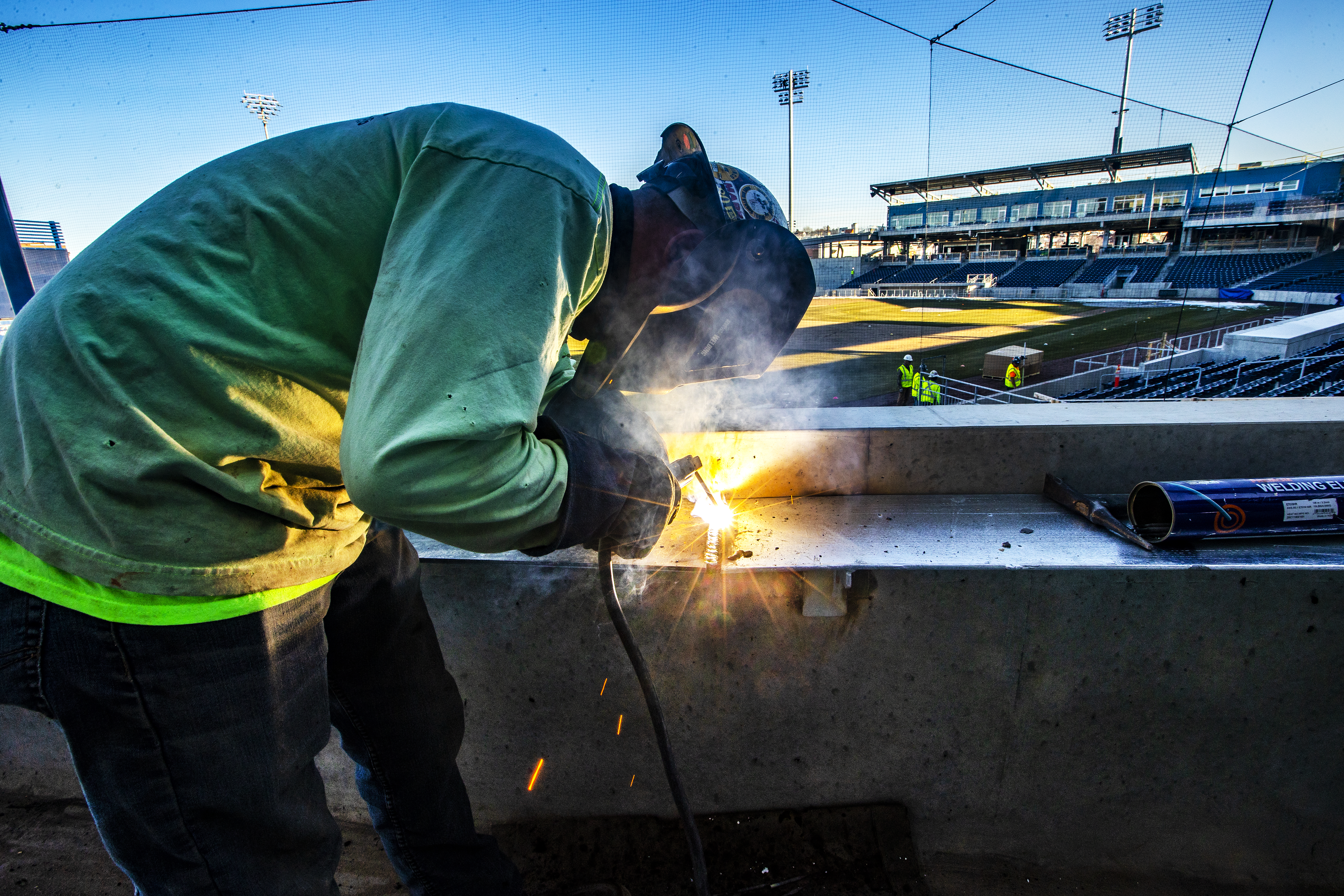A welder worked in left field at Polar Park.