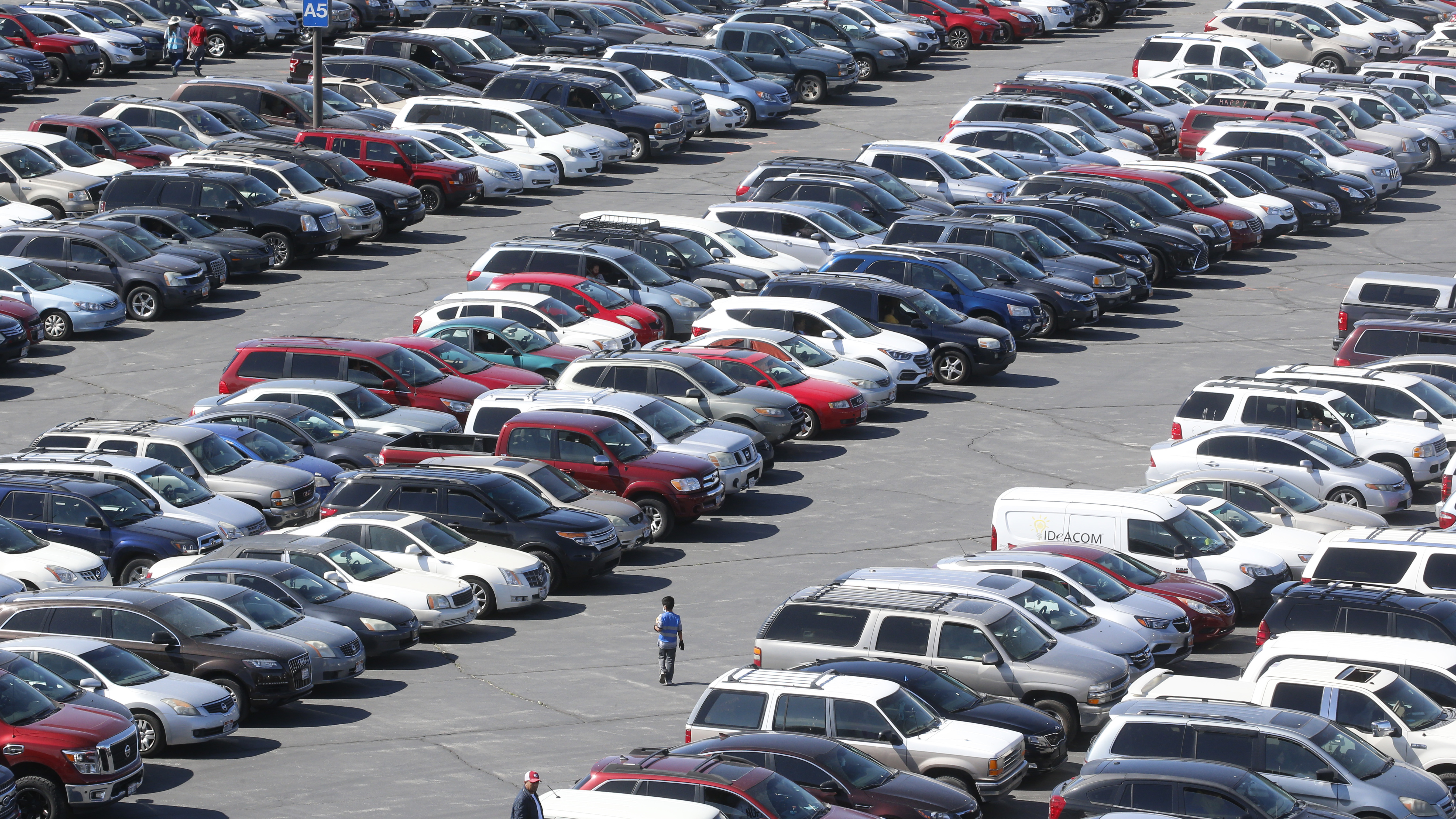 Cars line up for food at the Utah Food Bank's mobile food pantry at the Maverik Center, April 24 in West Valley City, Utah. As coronavirus concerns continue, the need for assistance has increased.