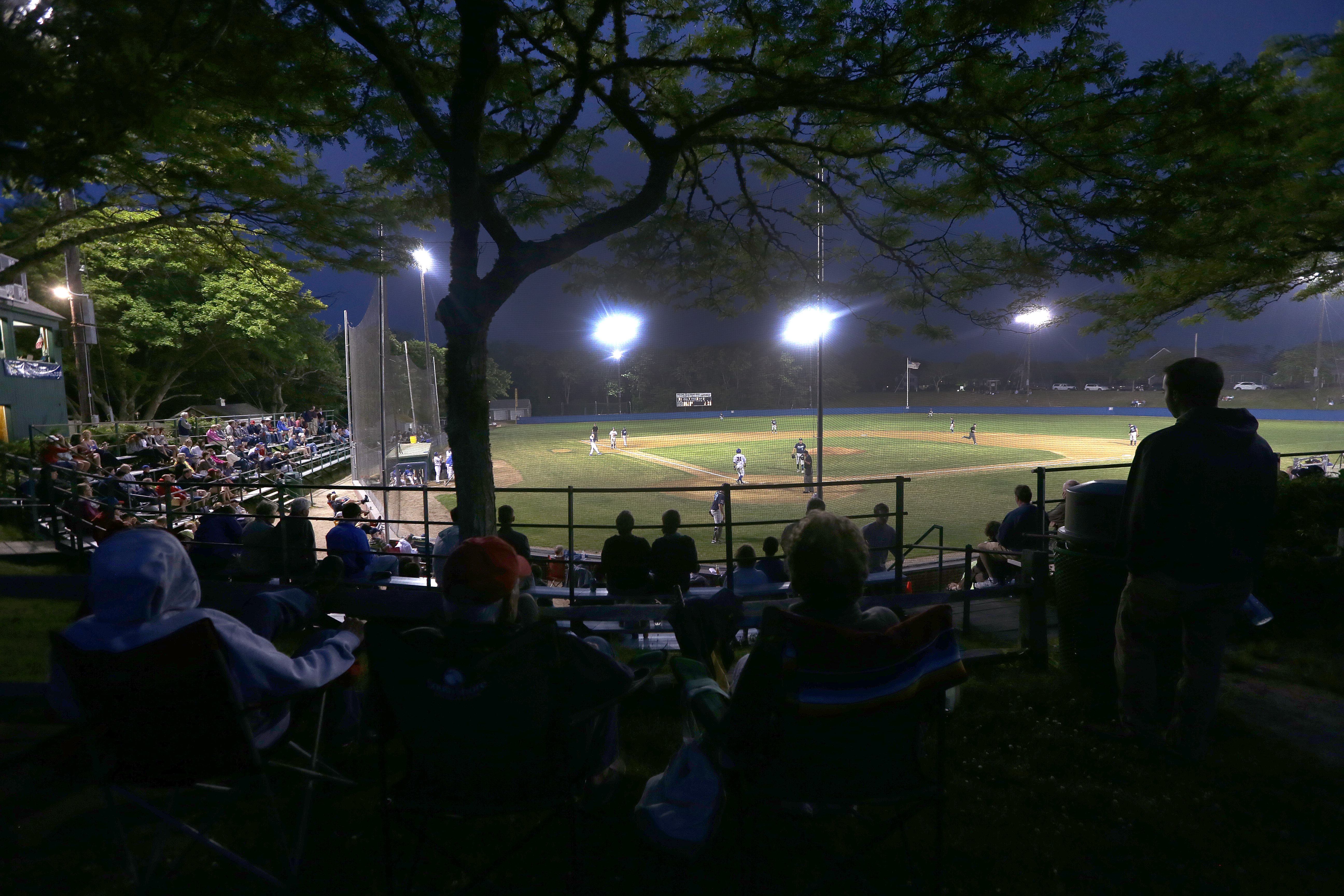Fans take in a night game between the Brewster Whitecaps and the Chatham Anglers, at Veterans Field in Chatham.