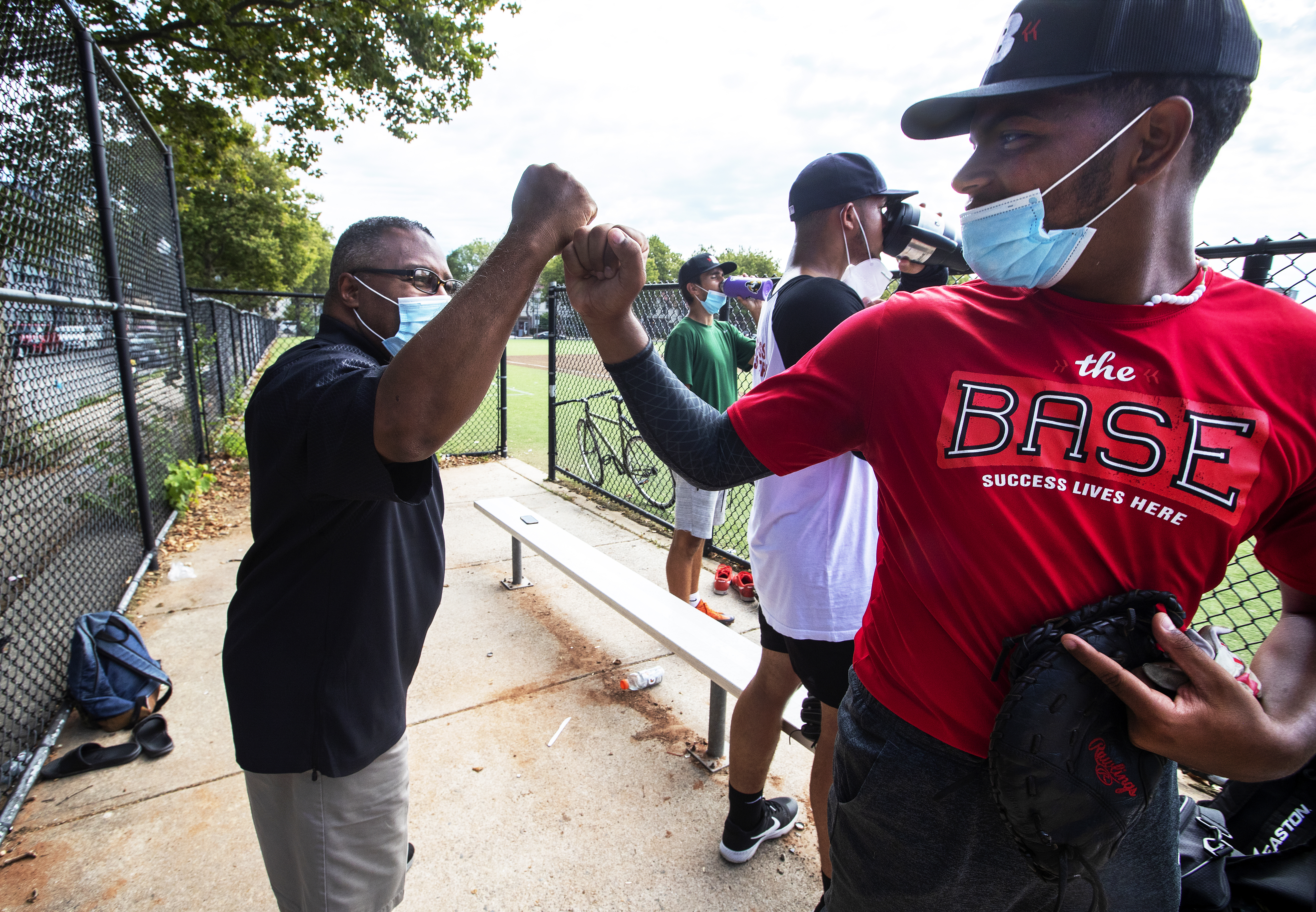 Robert Lewis Jr. (left), founder and president of The BASE, greeted Edwin Pena of the BASE Astros after a work out at Madison Park High School.