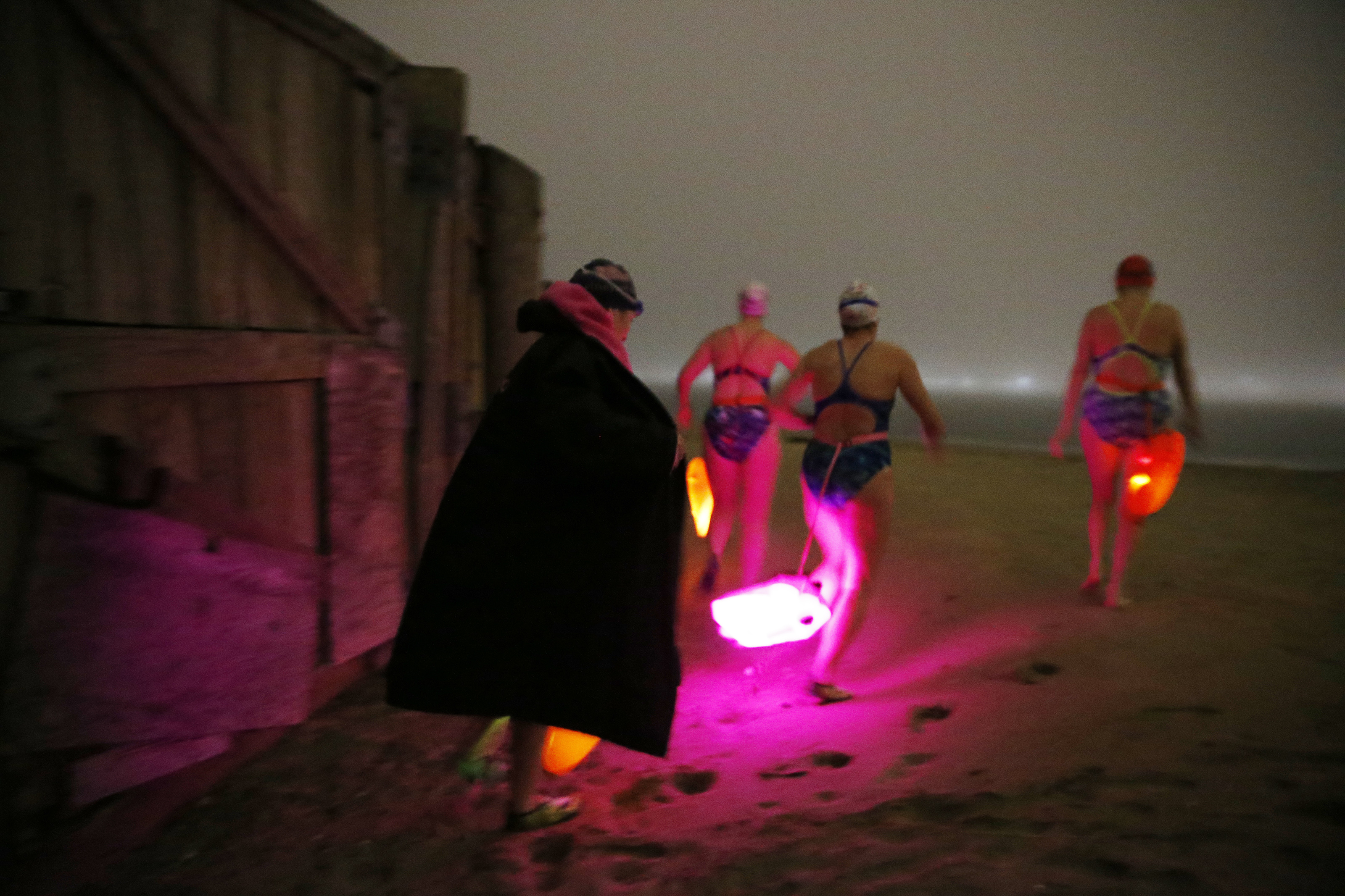 From left: Laurie Craigen, Kellie Latimer, Polly Madding, and Karen Nazor, swimmers from the L Street Bathhouse, headed out for an evening swim in Dorchester Bay last month.