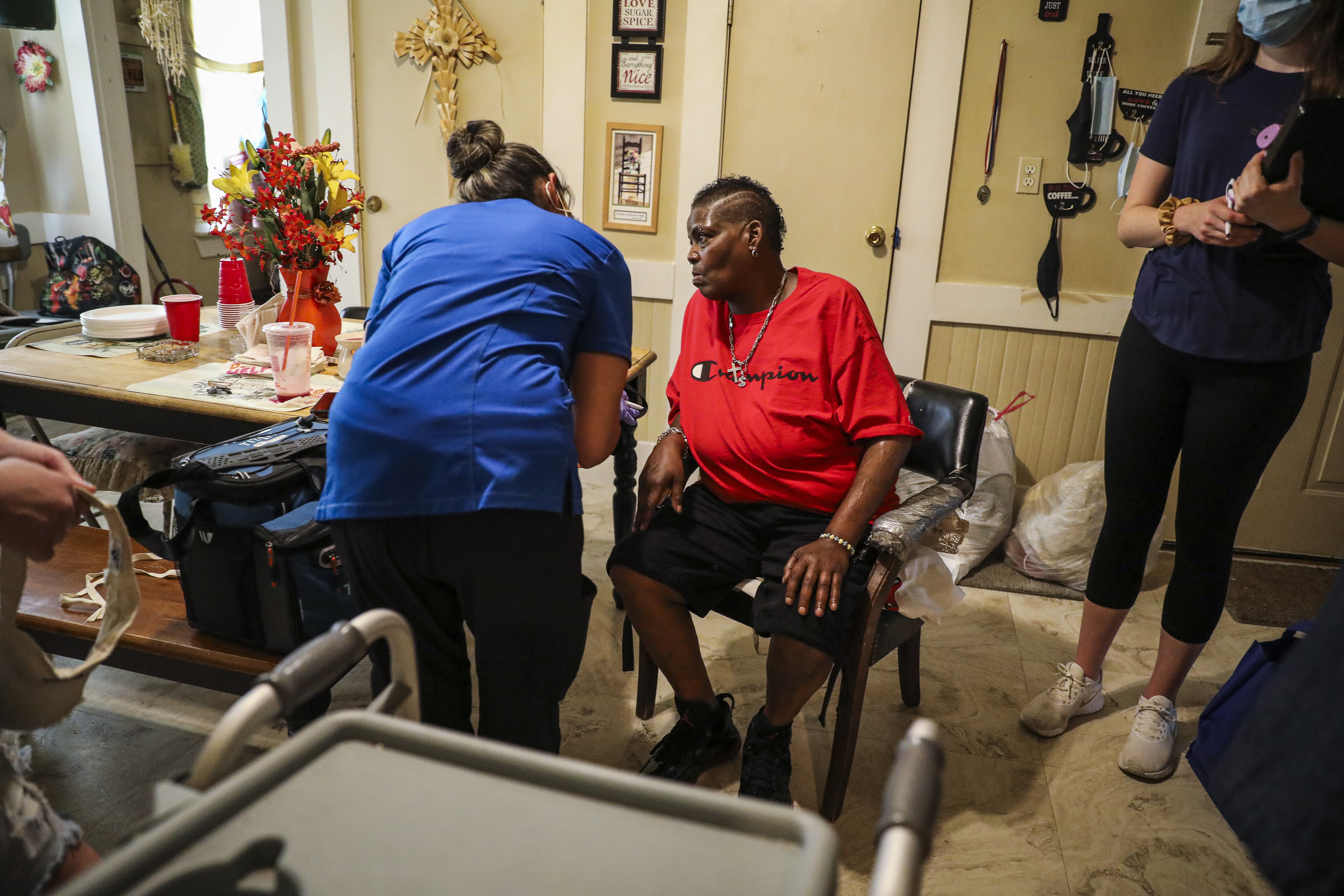 Nurse Naiya Patel helped homebound patient Geaylamar Artis fill out paperwork before she received her COVID-19 vaccine in Pittsfield.