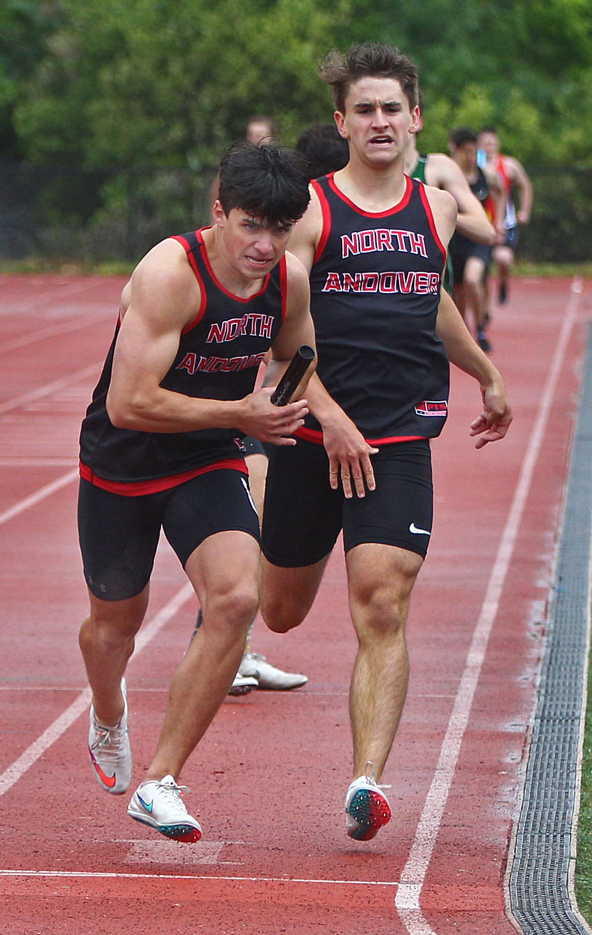 North Andover's Peter Martel takes the baton from Andrew Howard in the 4x400 relay.