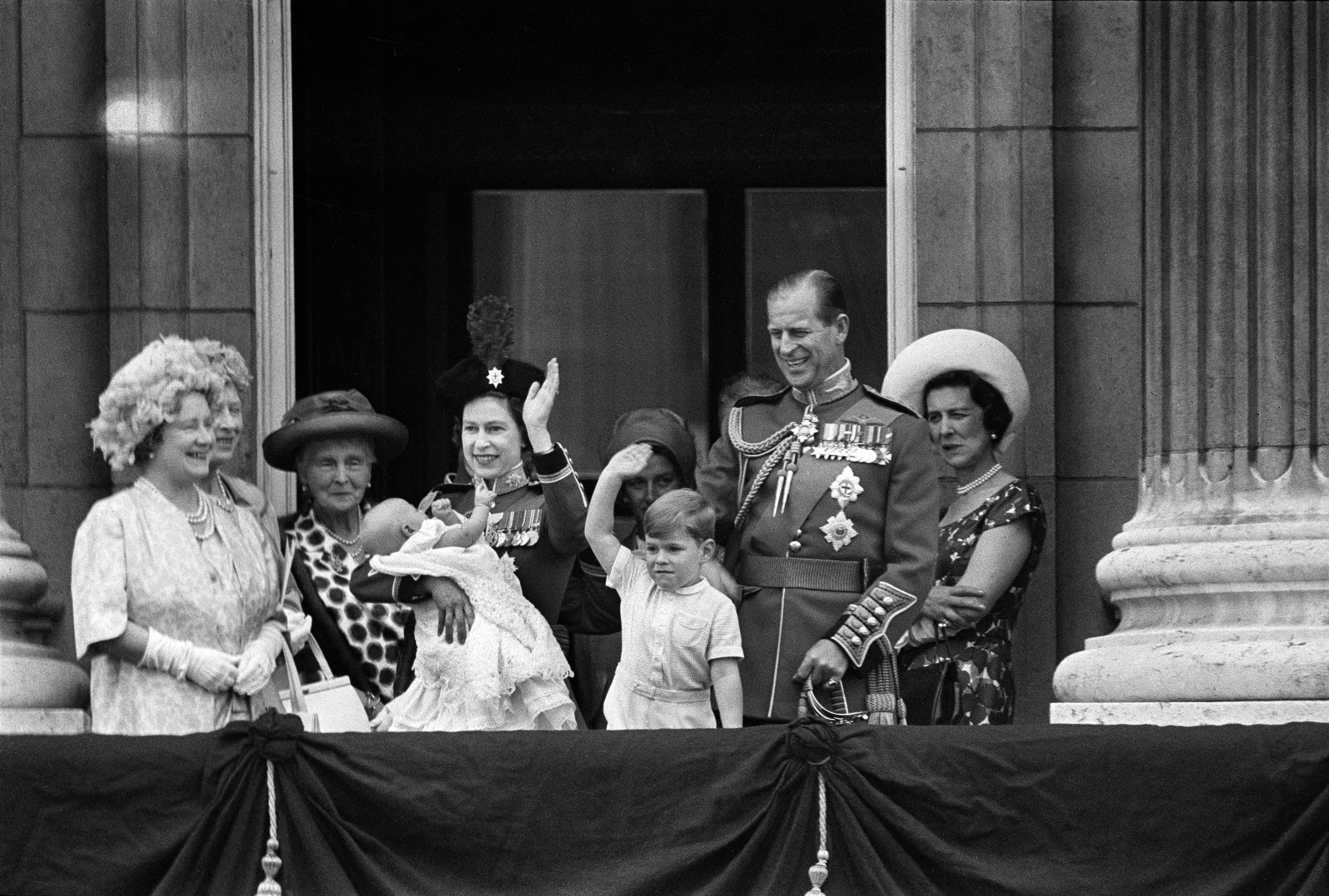 Queen Elizabeth and Prince Philip, both in uniform, on a balcony at Buckingham Palace in London on June, 13, 1964. The Queen is holding Prince Edward as Prince Andrew waves. Prince Philip, the Duke of Edinburgh, husband of Queen Elizabeth II, father of Prince Charles and patriarch of a turbulent royal family that he sought to ensure would not be Britain’s last, died on Friday, April 9, 2021, at Windsor Castle in England.