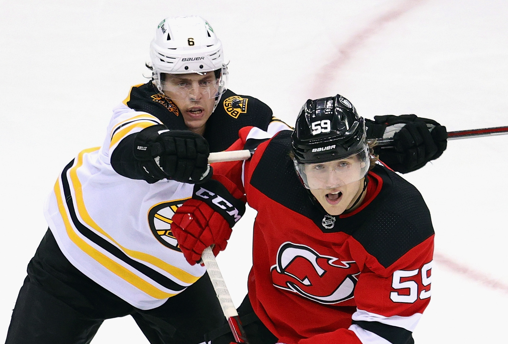 Mike Reilly jousts with New Jersey's Janne Kuokkanen during the physical third period of Tuesday's game.