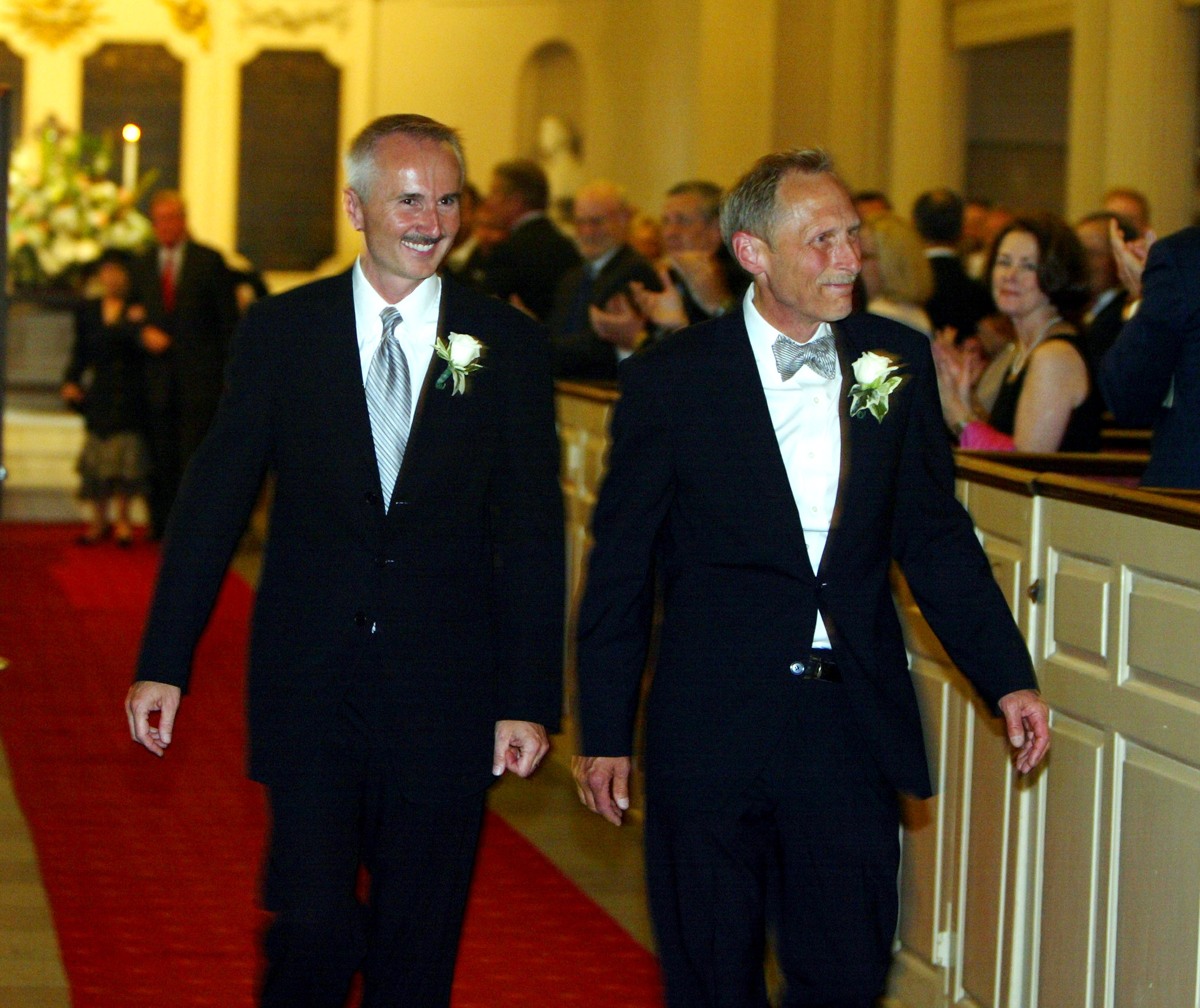 Kevin Smith, left, and Mitchell Adams walk down the aisle of King's Chapel after their wedding ceremony in 2004.