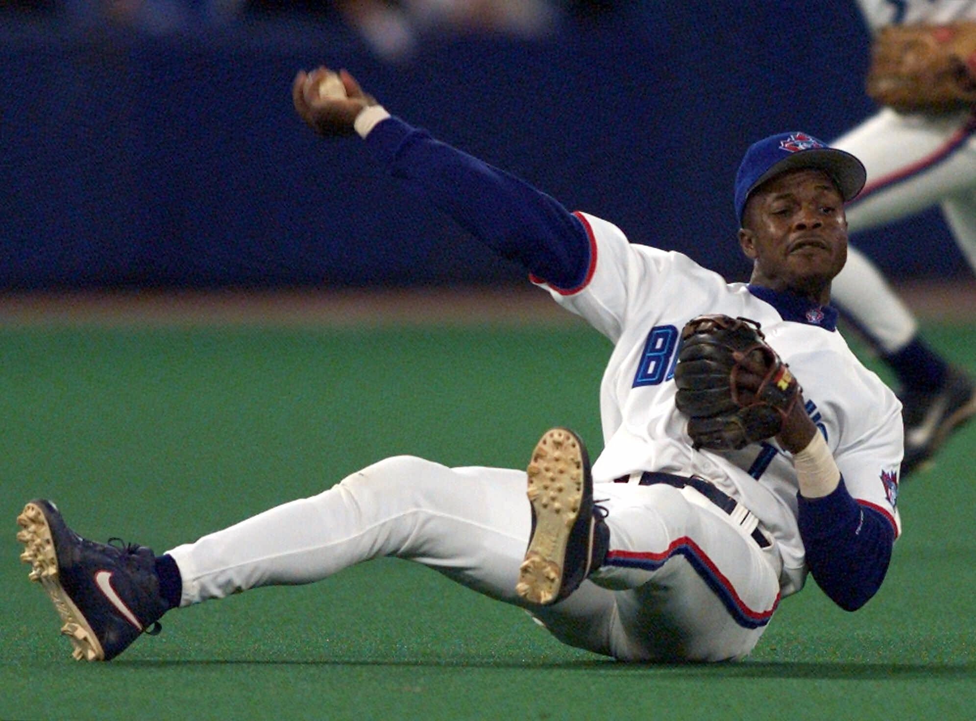 Tony Fernandez makes a throws from the turf while playing third base for the Blue Jays.