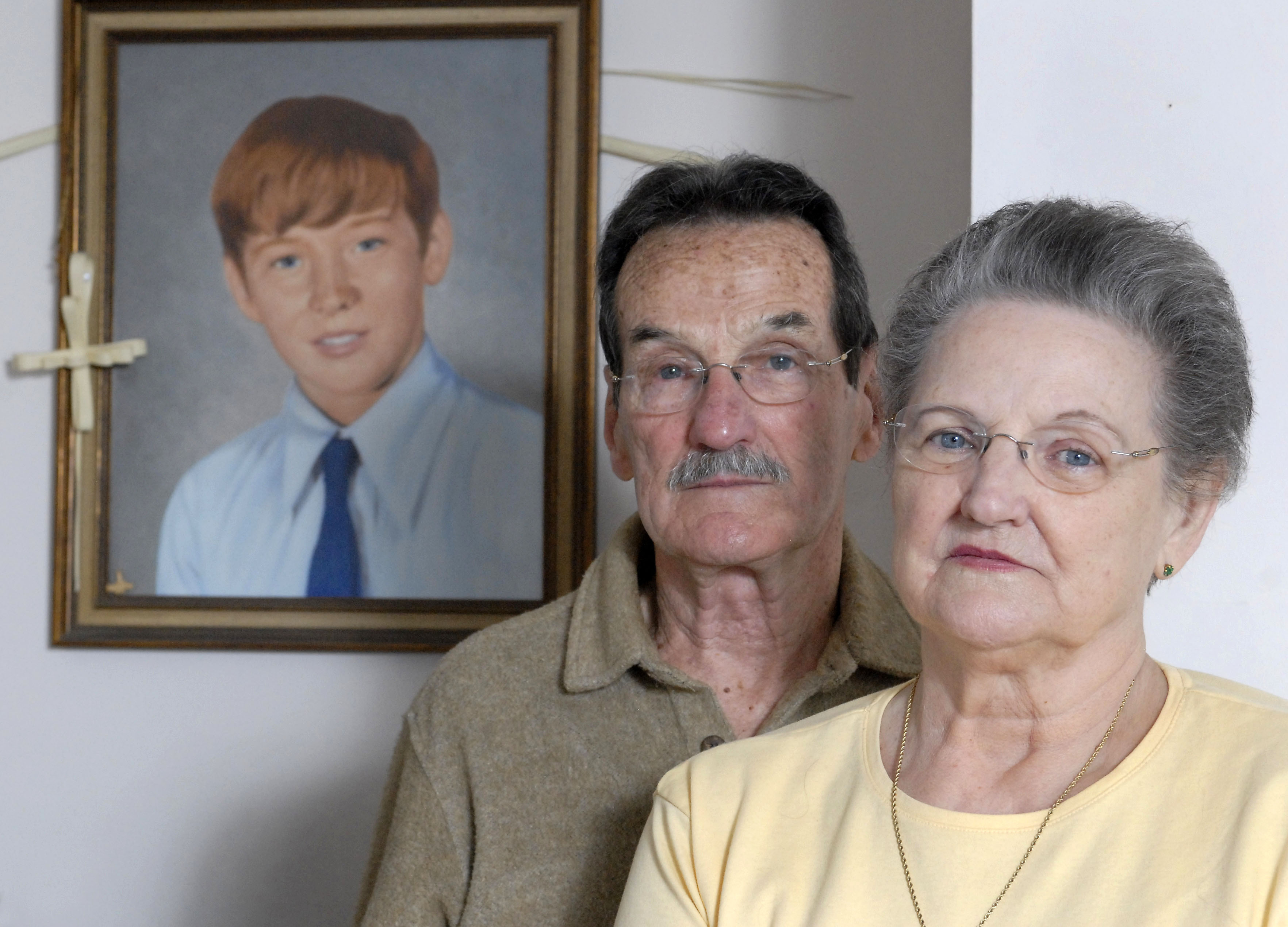 A 2008 photo shows Carl and Bunny Croteau with a portrait of their murdered son, Danny.