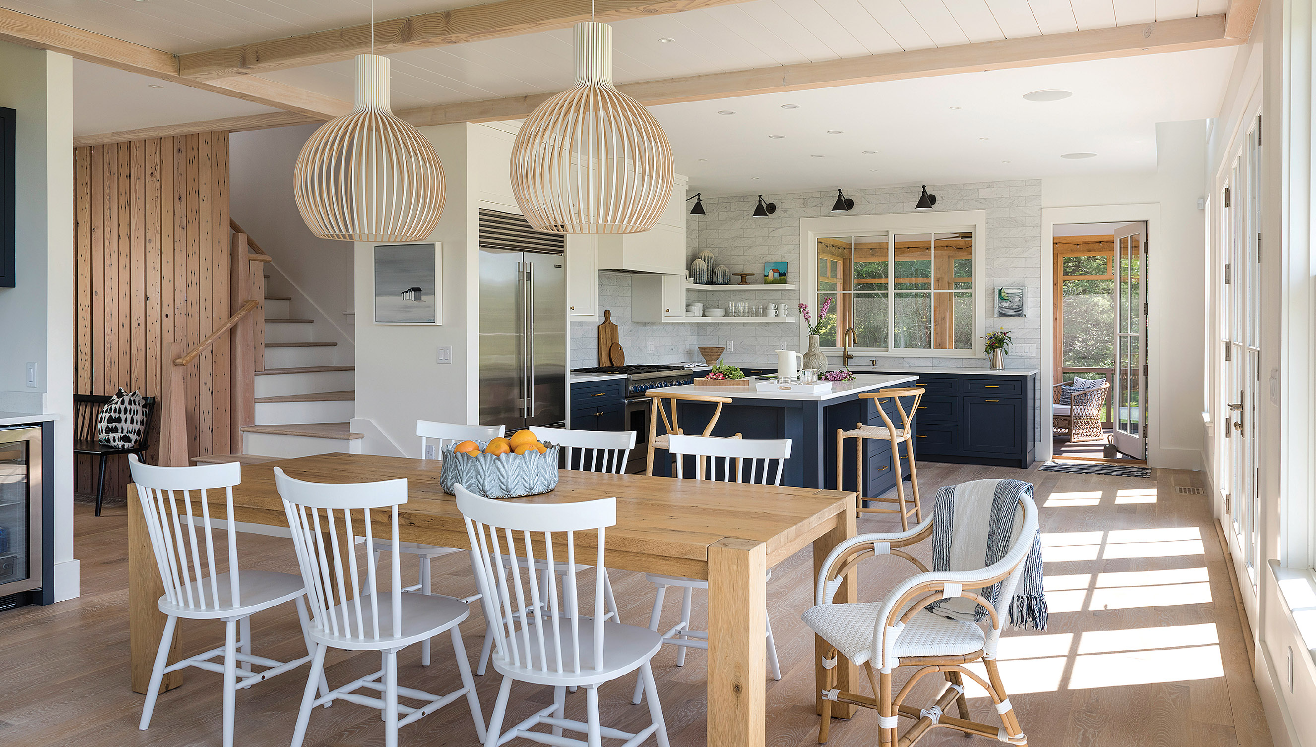 A pair of Octo pendants by Secto Design blend with the ceiling but still make a statement. “One wouldn’t have been enough,” designer Jessica Del Prete says. The curvy end chair is from Serena & Lily.