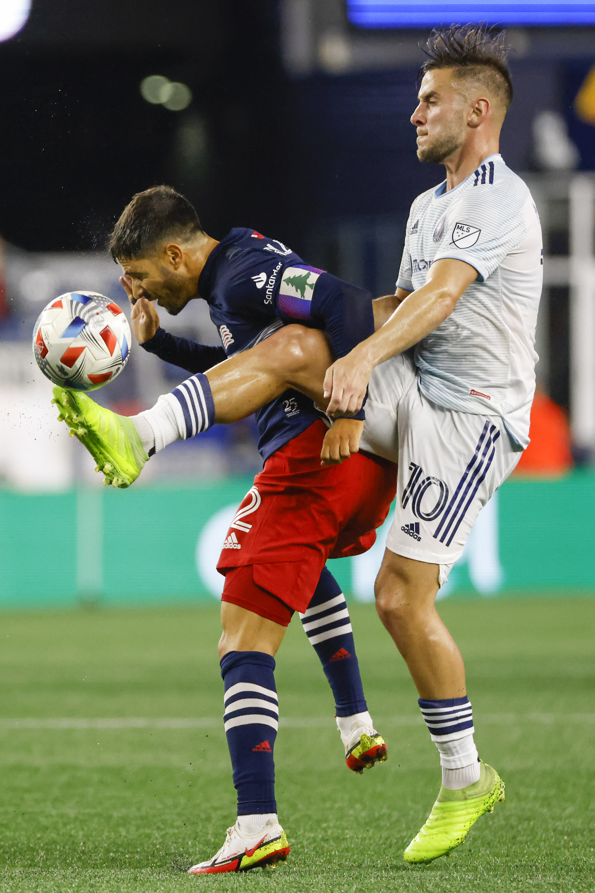 Chicago Fire midfielder Alvaro Medran battles with Revolution defender Carles Gil.