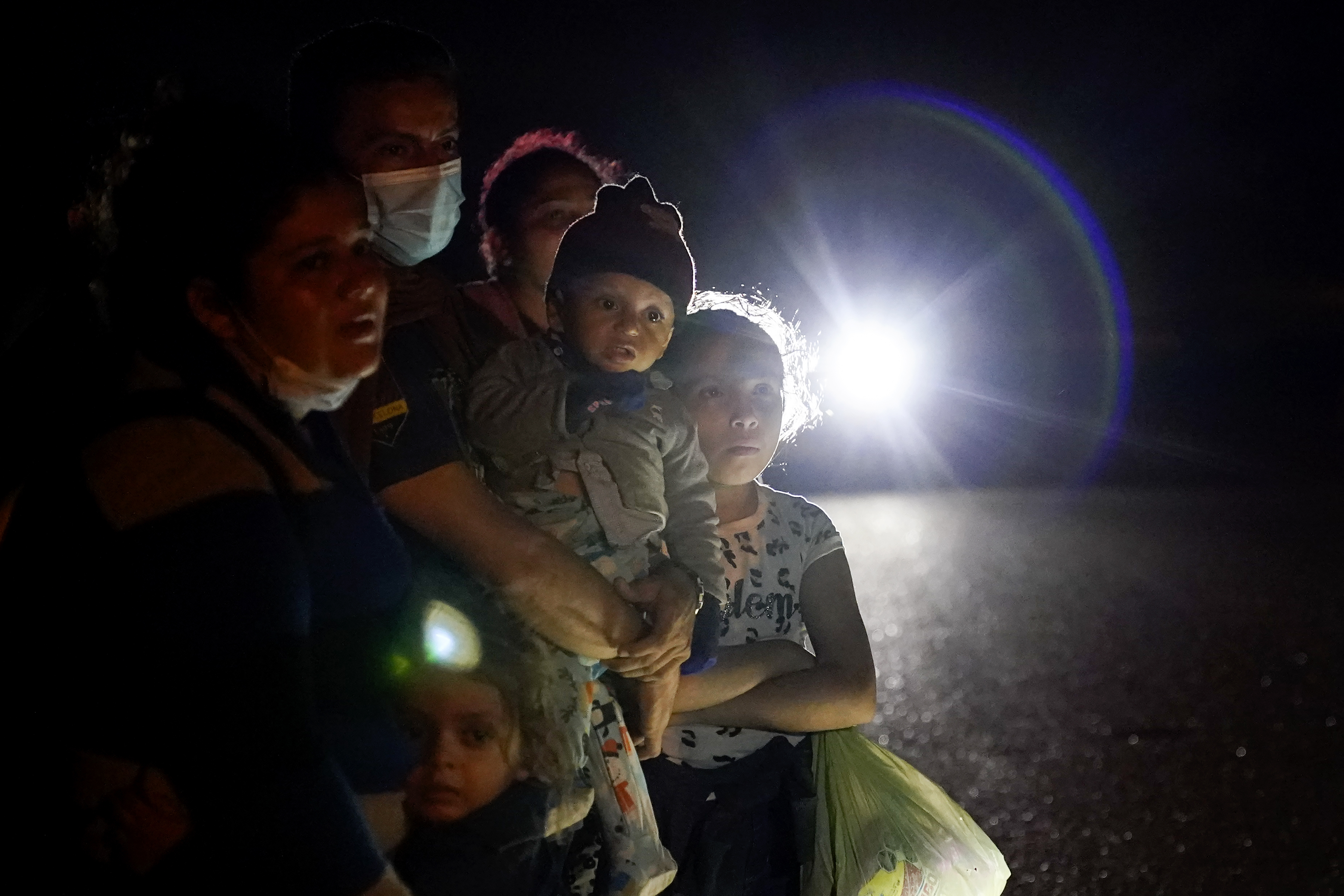 A group of migrants from Honduras and Nicaragua waited along a road in La Joya, Texas, after turning themselves in upon crossing the border in May.