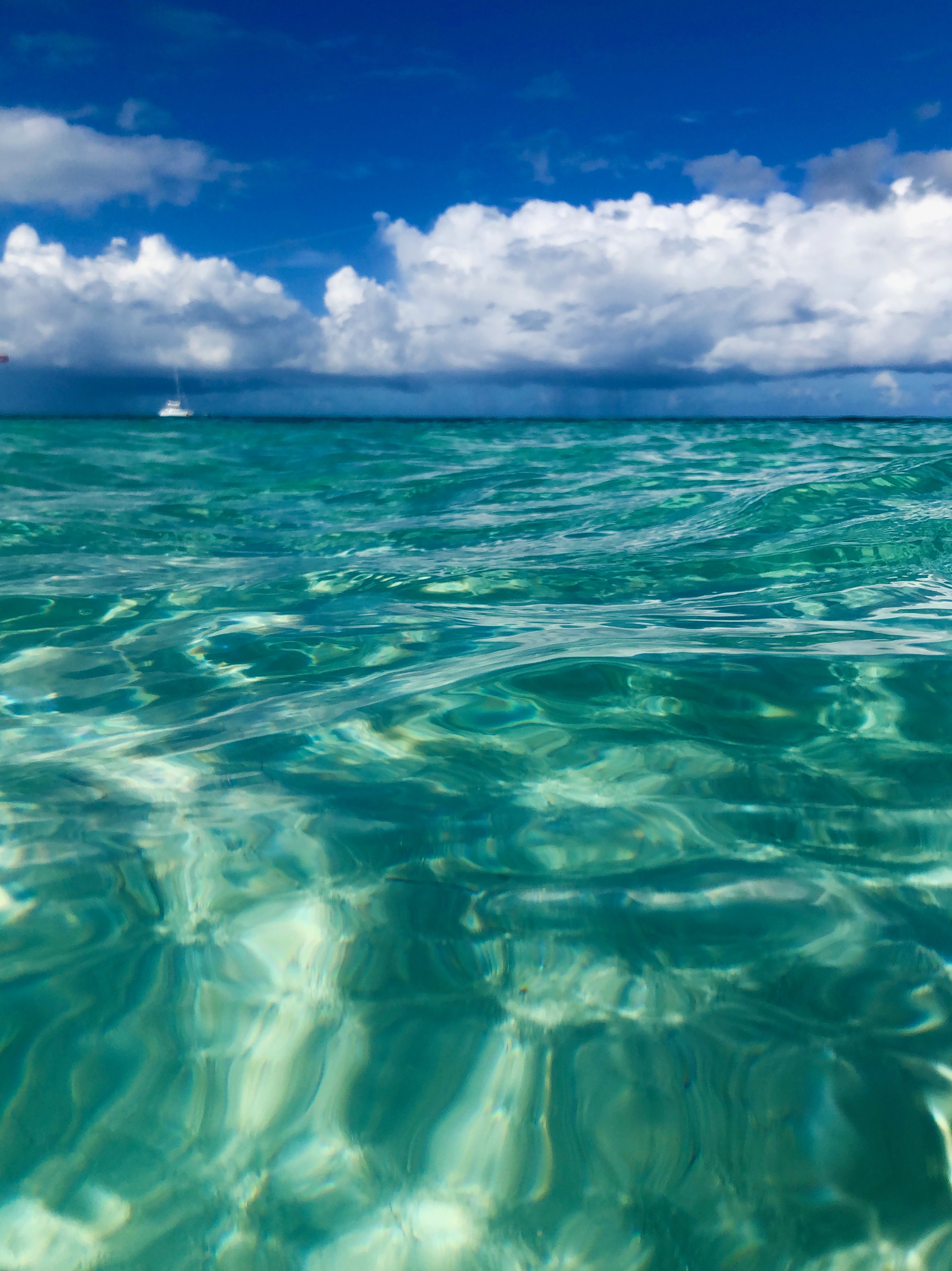The view of a distant boat from Bight Beach in Turks and Caicos.