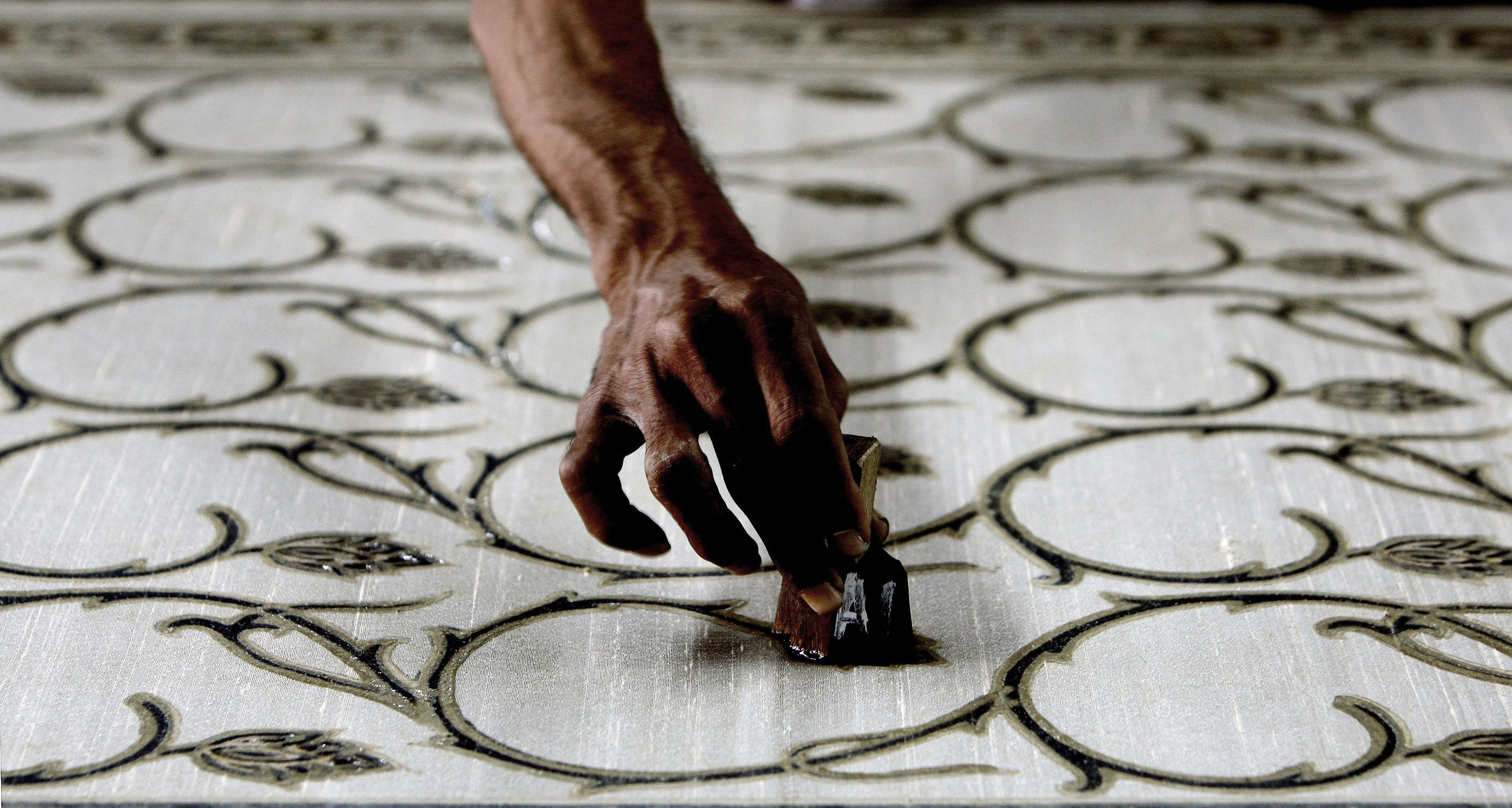 An Indian craftsman in Mumbai makes a block print on a natural-dye sari.