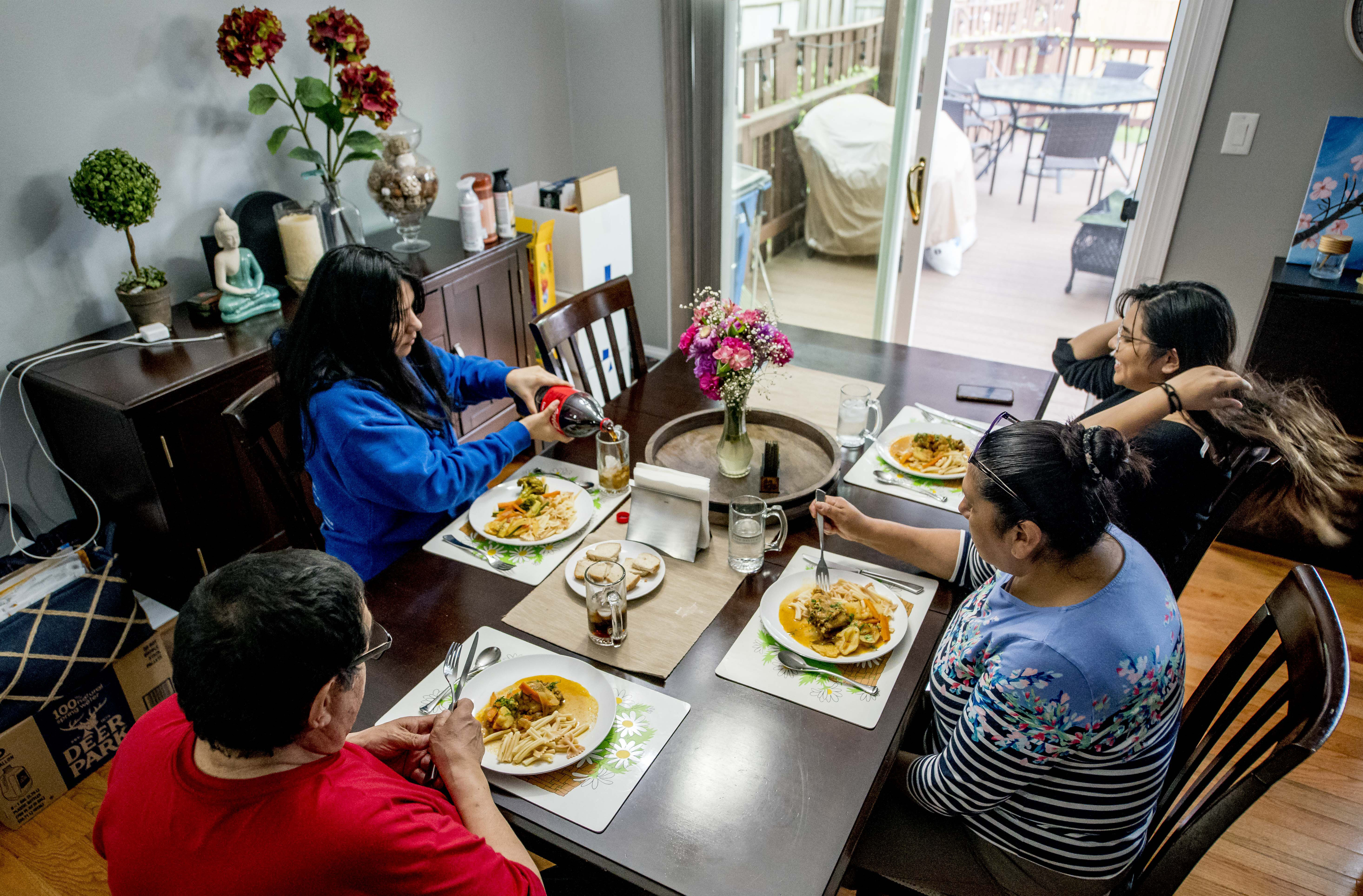 Luz Chavez and her family sit down for dinner.