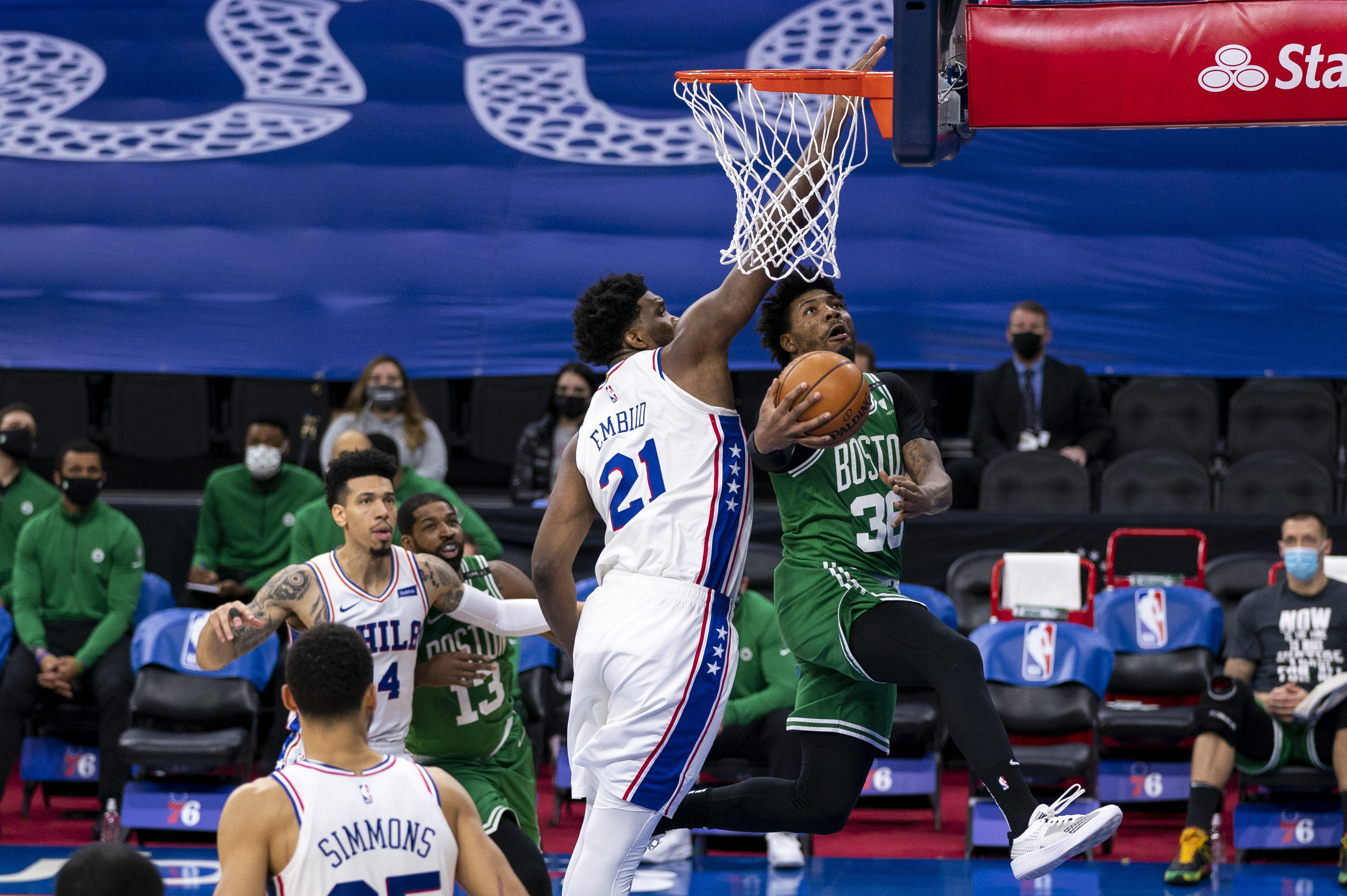 Marcus Smart goes to the basket against Philadelphia's Joel Embiid Wednesday night.