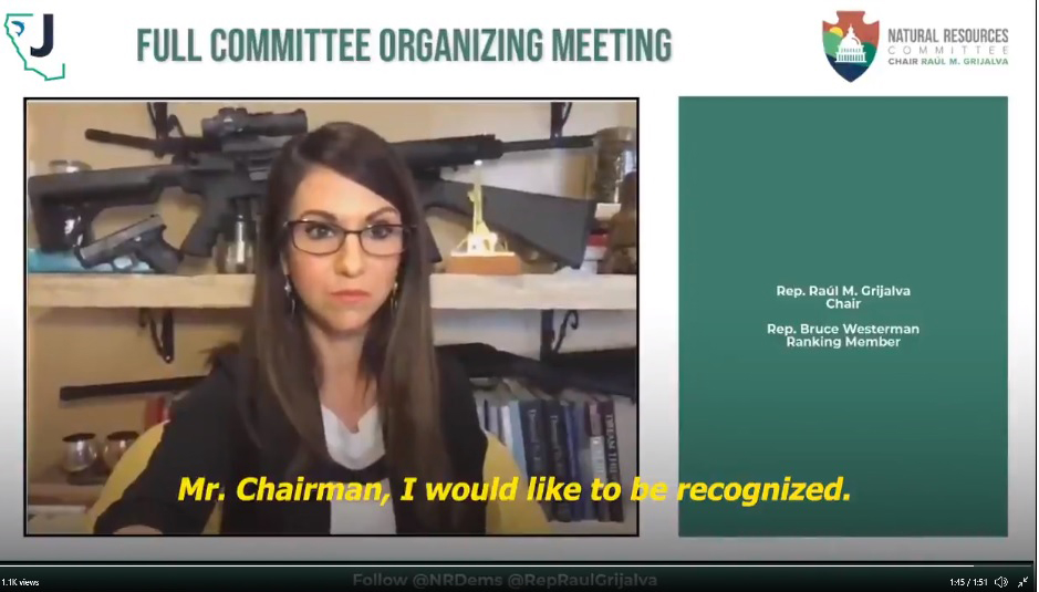 Representative Lauren Boebert with weapons arrayed behind her during a virtual meeting of the House Natural Resources Committee on Feb. 18.