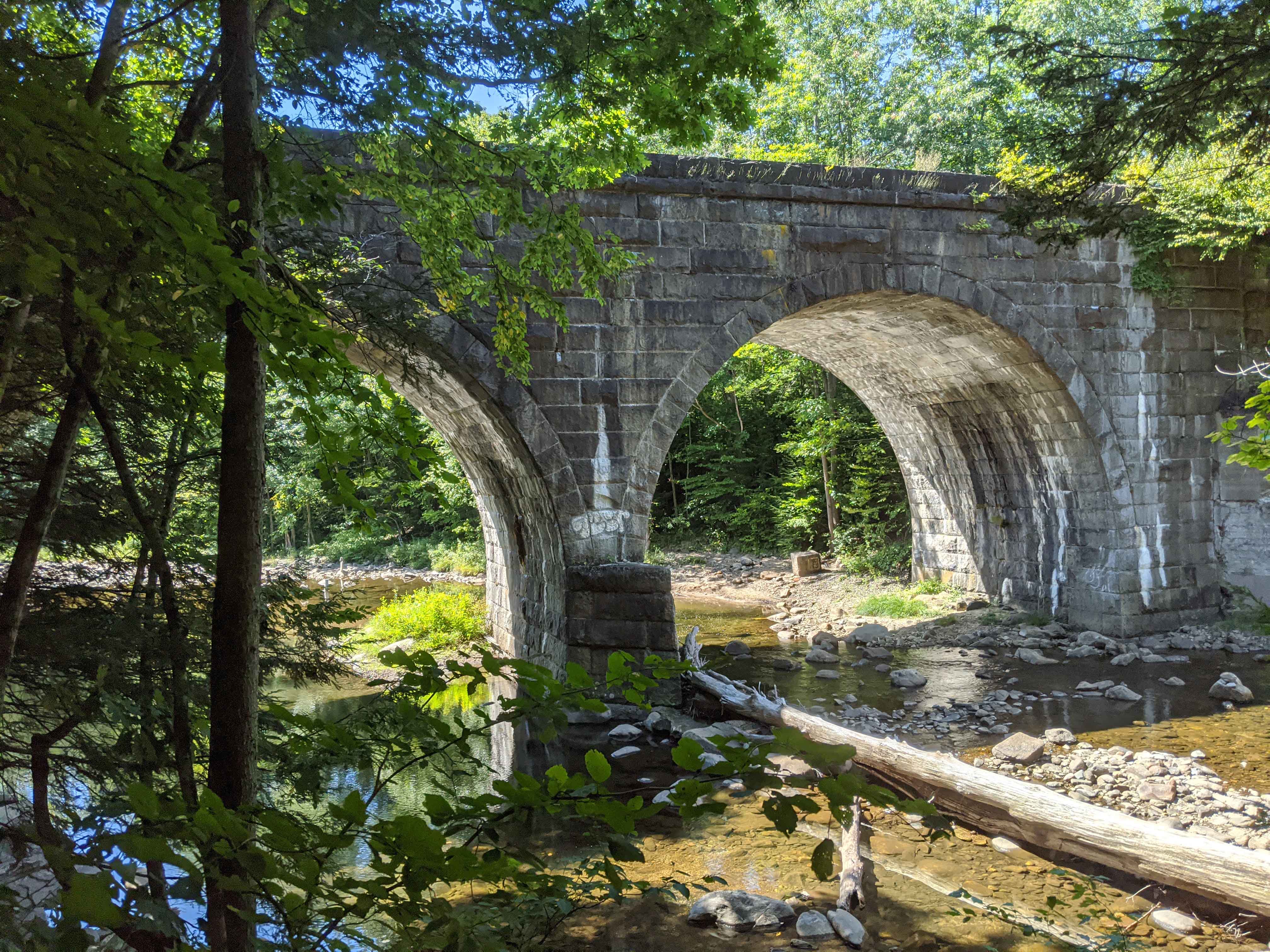 This double keystone arch railroad bridge, constructed 1839-41, still carries freight trains over the west branch of the Westfield River. It's located near the trailhead of the Keystone Arch Bridges Trail.