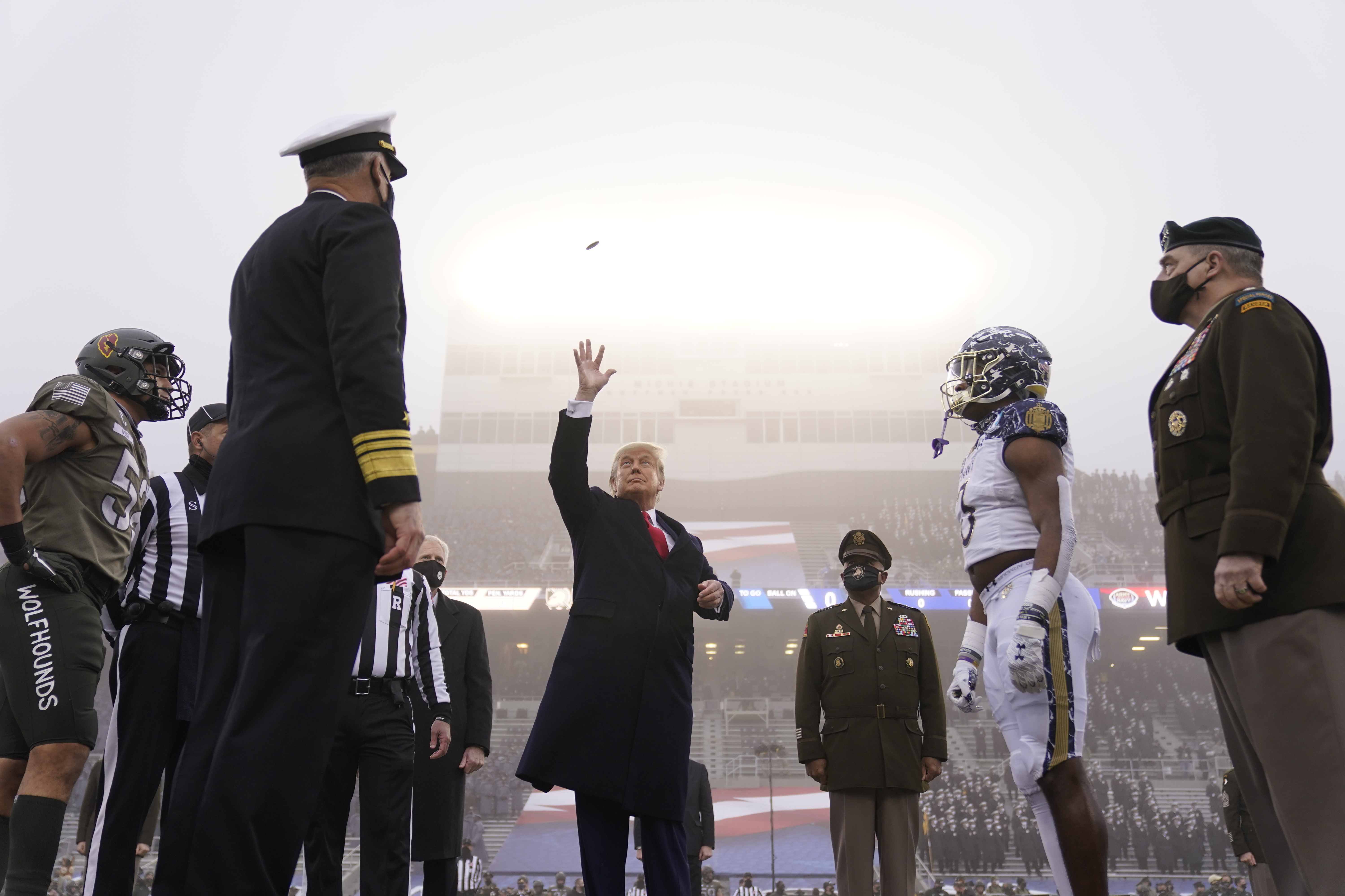 President Trump throws the coin in the air before the start of the 121st Army-Navy Football Game on Saturday in West Point, N.Y. (AP Photo/Andrew Harnik)