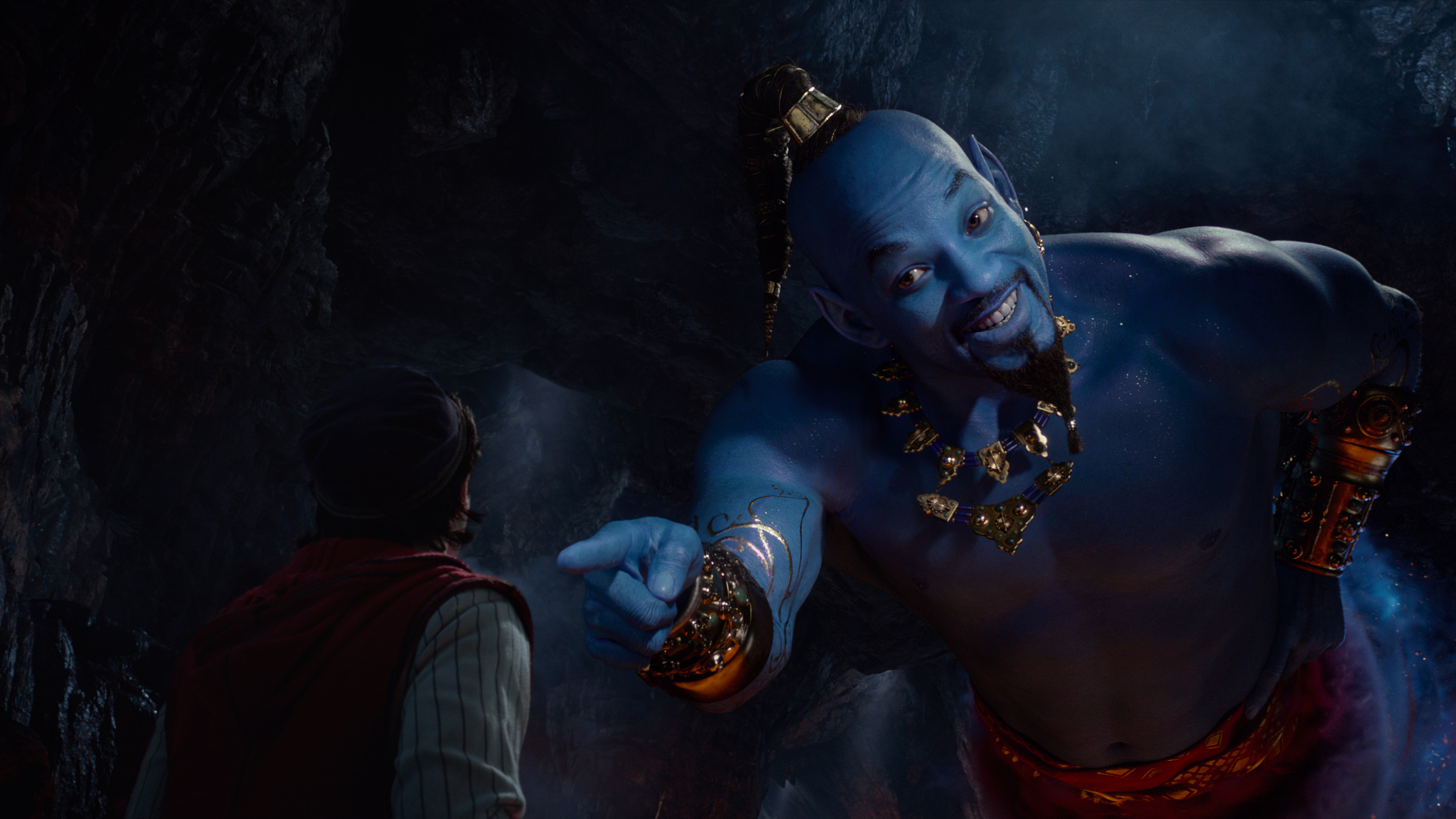 Aladdin (Mena Massoud) meets the larger-than-life blue Genie (Will Smith) in Disney’s live-action adaptation of “Aladdin.”