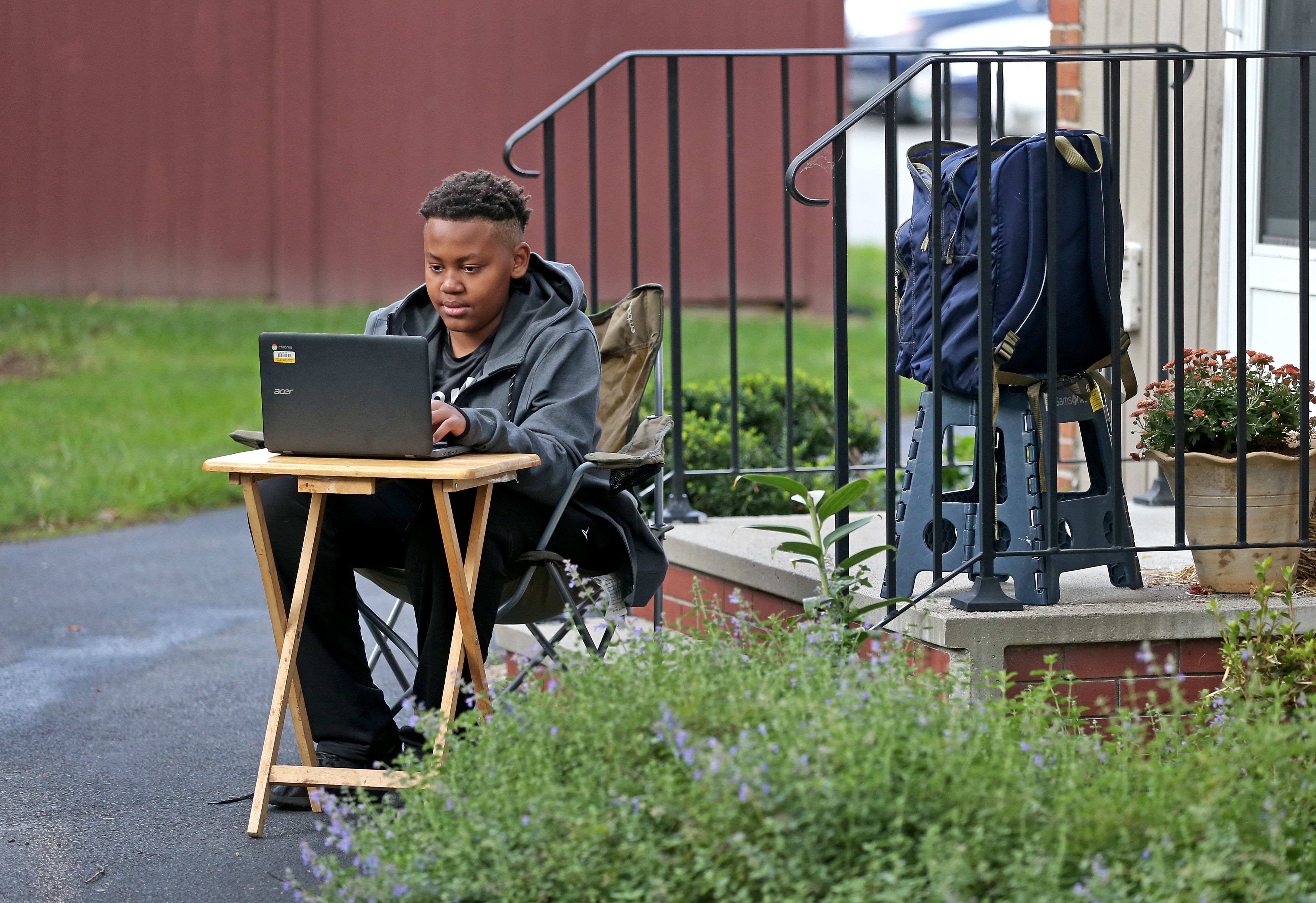 In Roxbury, a makeshift classroom was set up outdoors by Angelina Camacho for her son Christopher Taylor, 12, at their home.