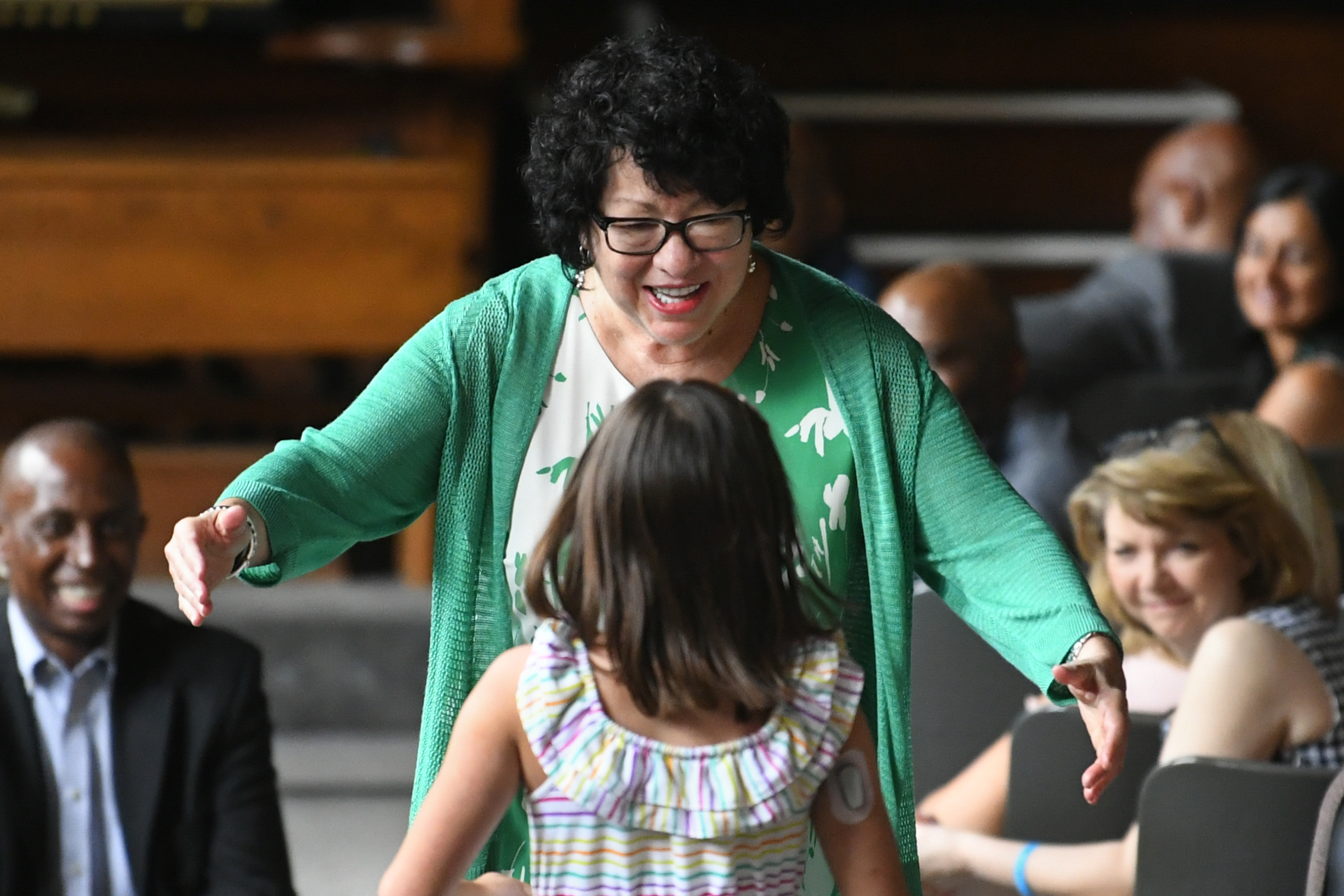 Supreme Court Justice Sonia Sotomayor reached out to hug a child during an event promoting her children's book "Just Ask!" in Decatur, Ga., in 2019.
