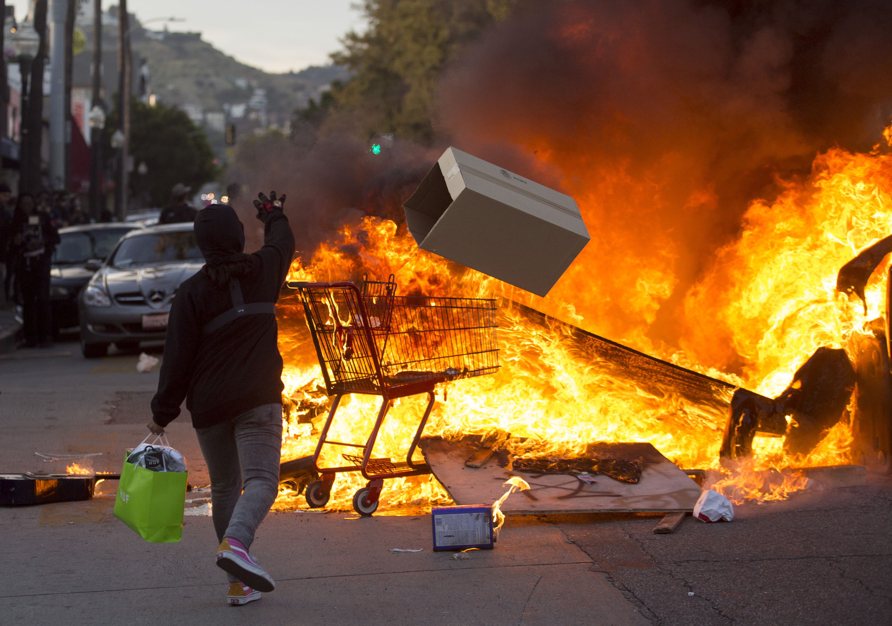 A protester threw items in to a fire during a protest in Los Angeles over the death of George Floyd.