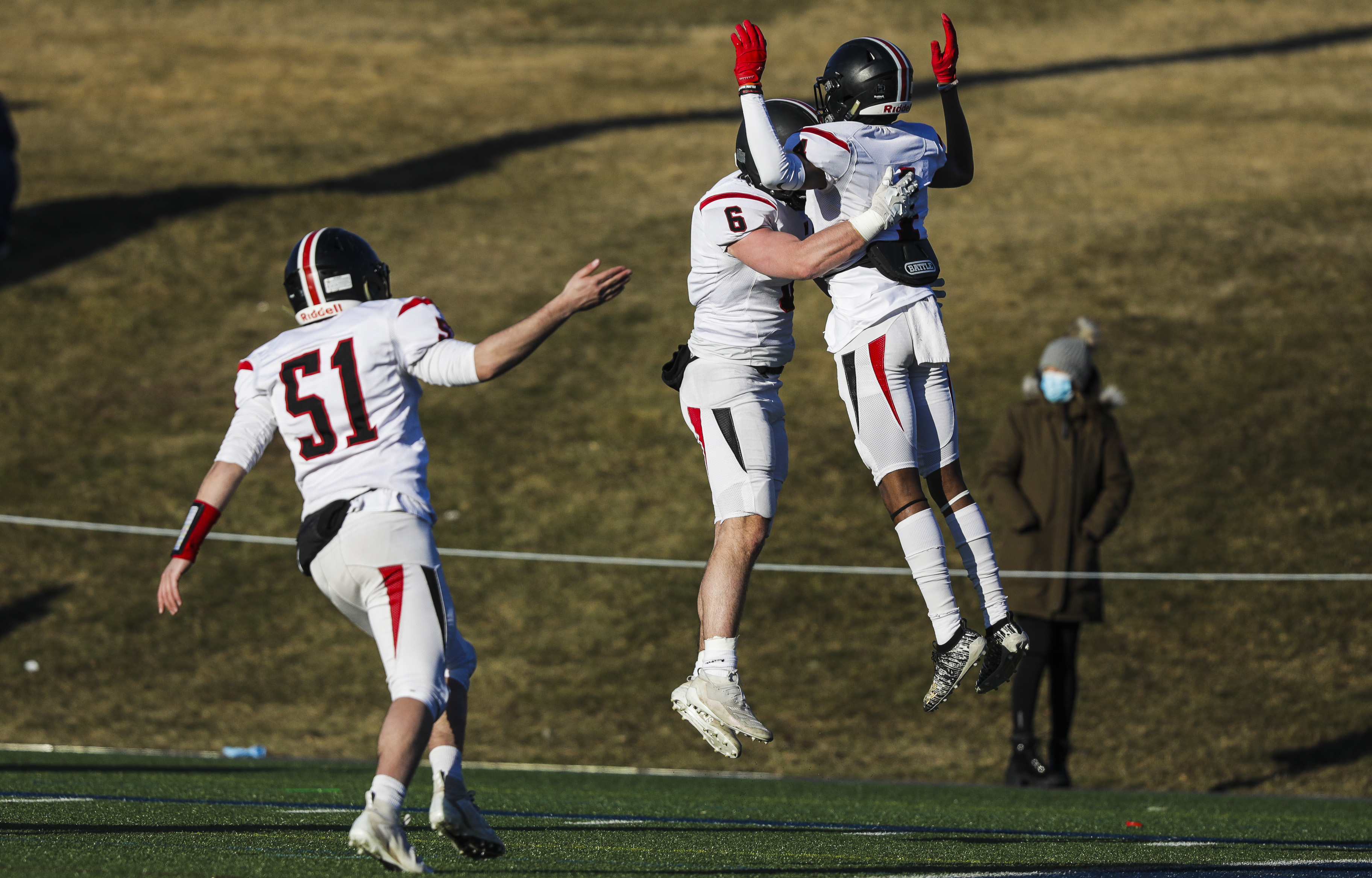 Wellesley's Carl Callahan (6) and Wedner Cadet (4) were flying high as they celebrate a touchdown during their win over Needham.