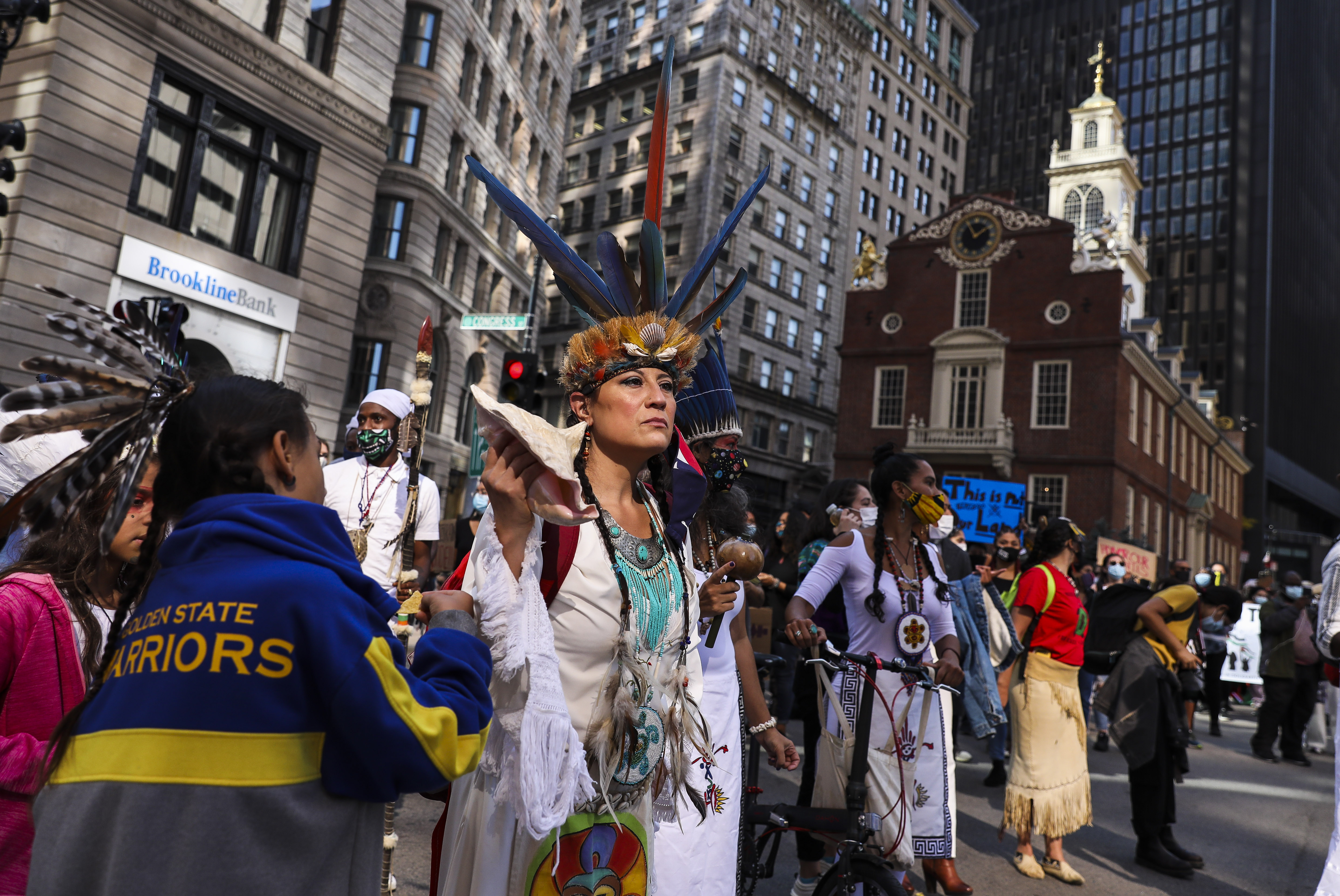 Chali'Naru Dones, with the United Confederation of Taino People, marches past the Old State House while participating in the Indigenous Peoples Day rally and march on Saturday afternoon.